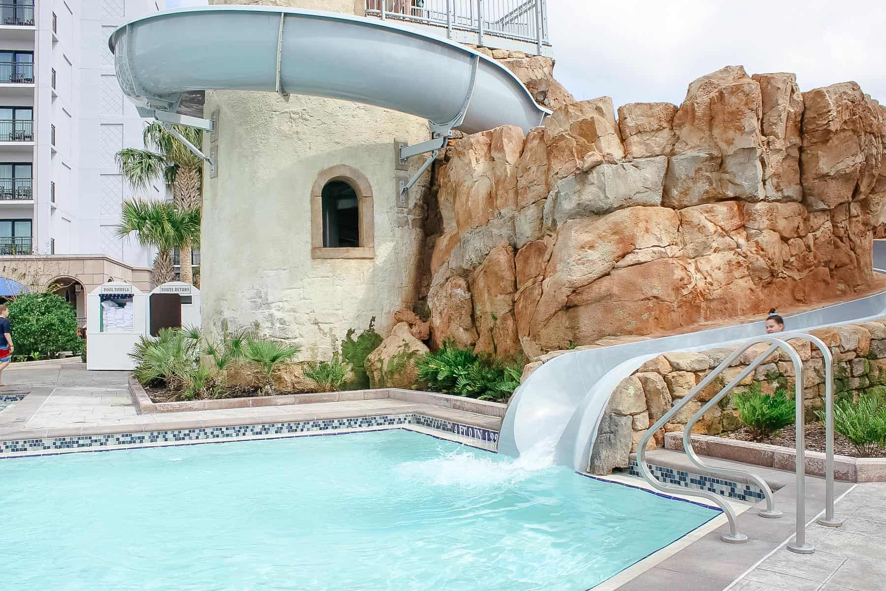 the water slide as it wraps around the tile and flows through the rocks 