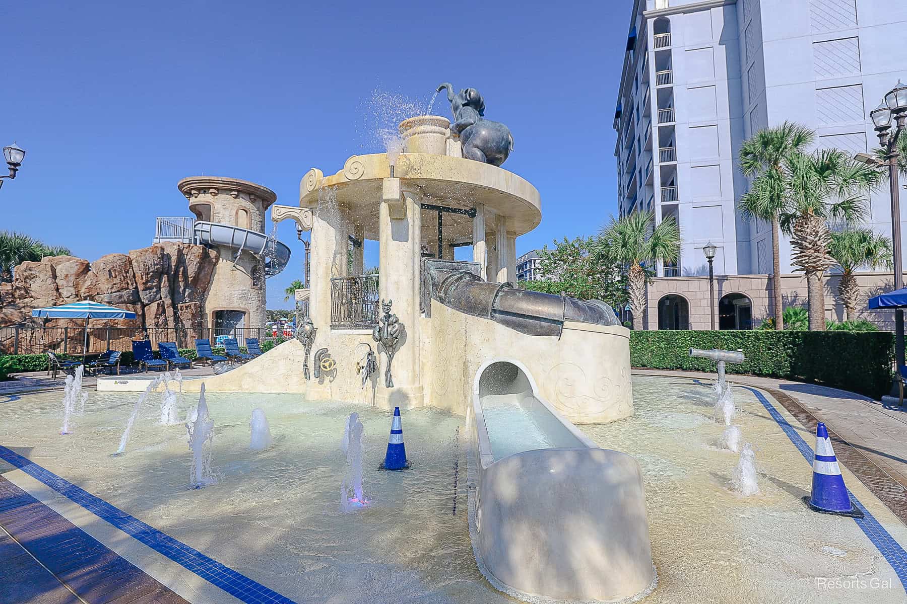 a view of the pool area that shows the elephant water feature on top
