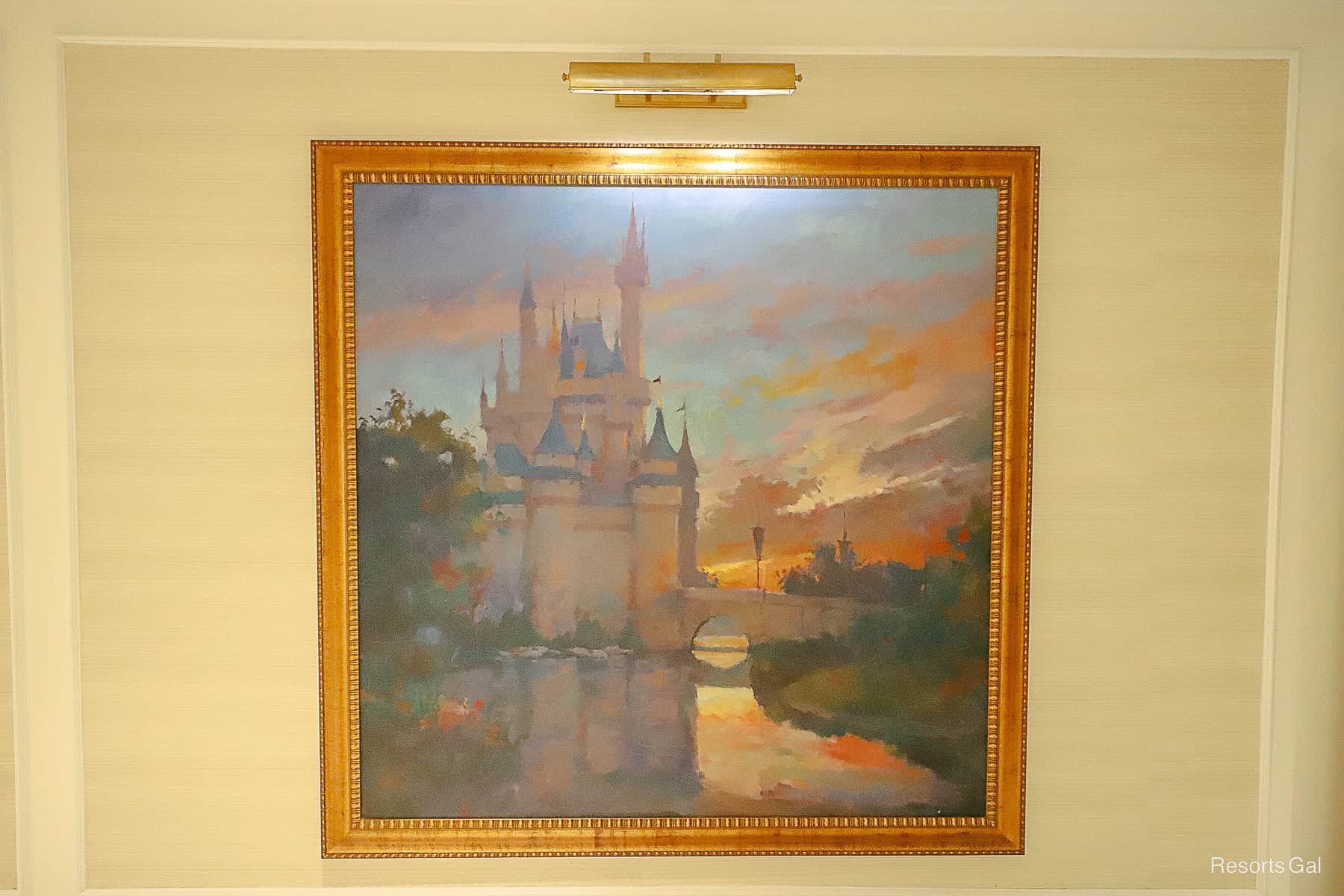 a framed painting featuring Cinderella Castle at sunset 