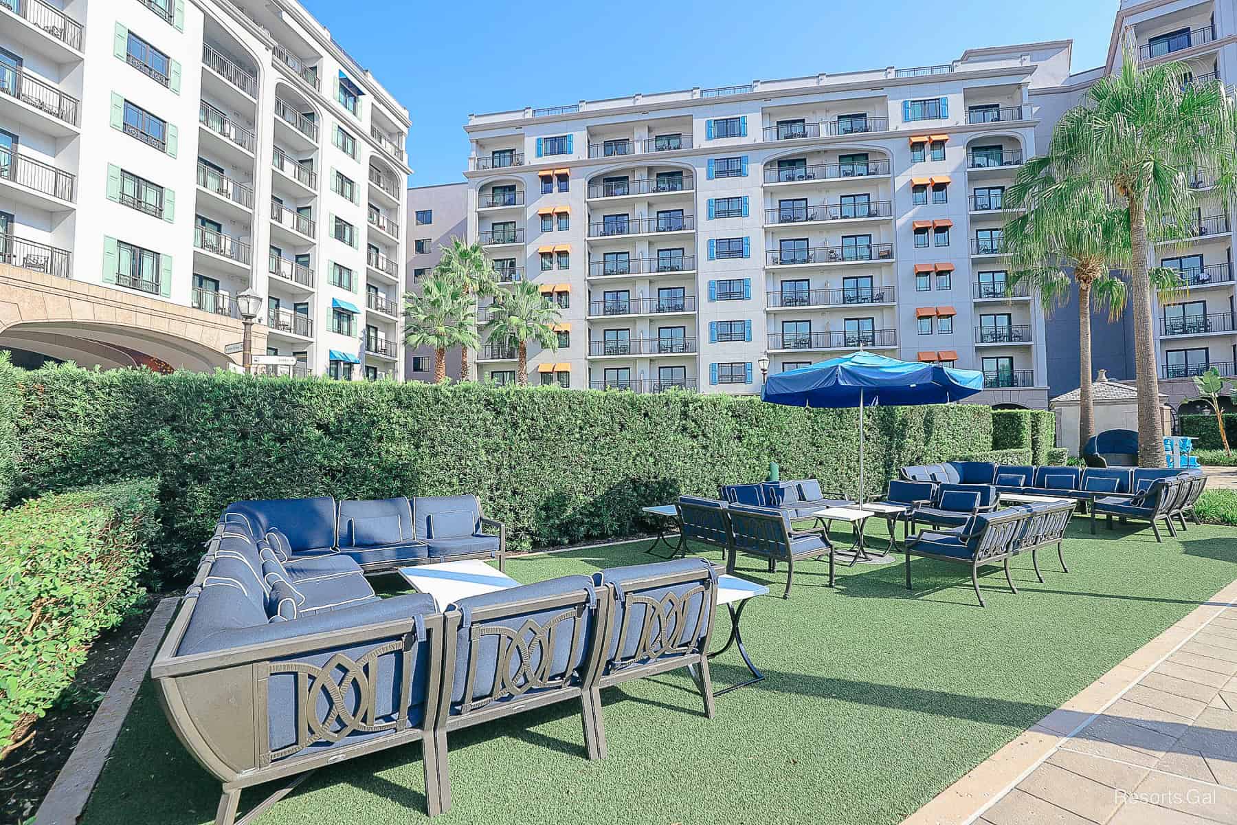 an area with lounge chairs adjacent to the Beau Soleil Pool