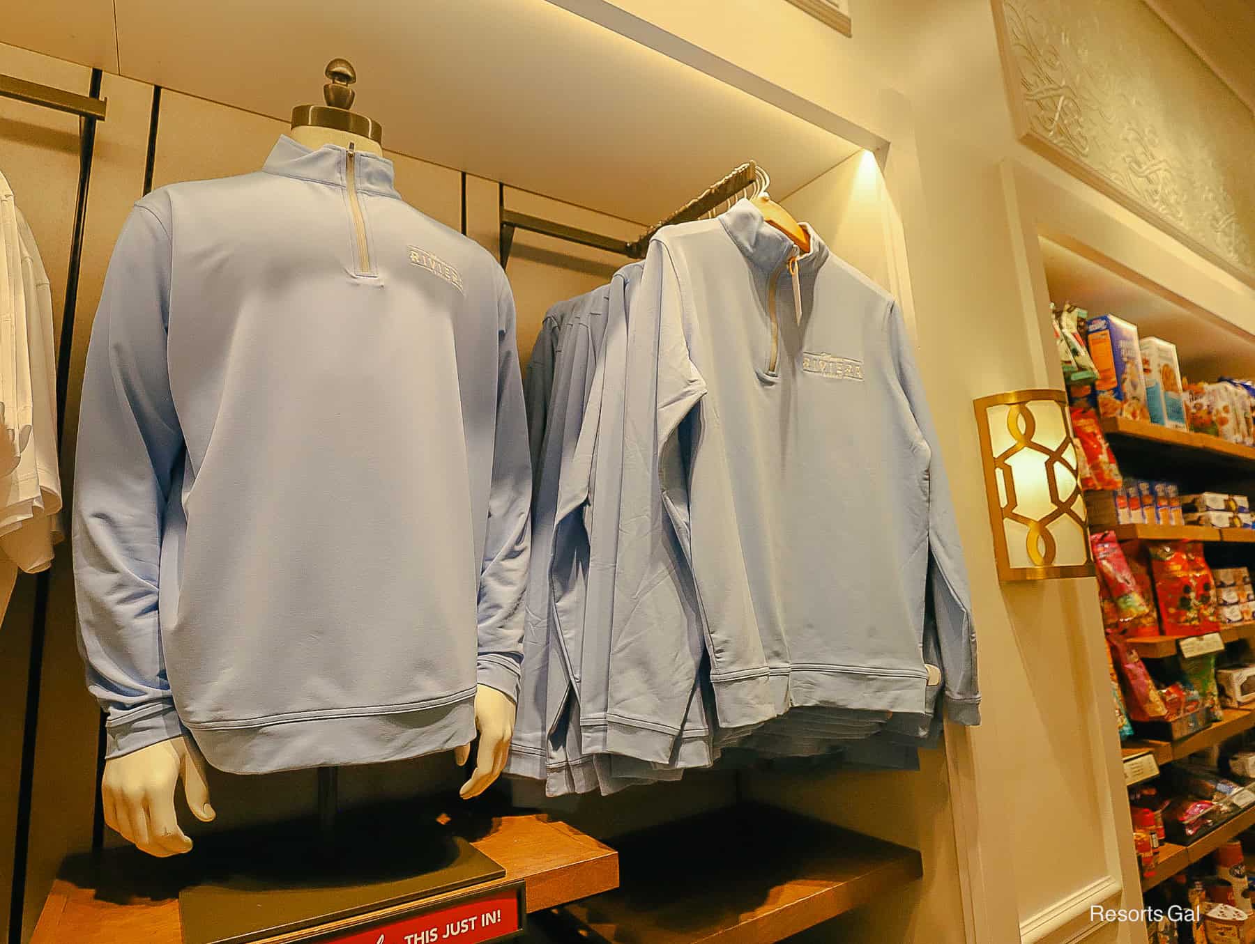 a light blue Peter Millar pullover with the Riviera logo 