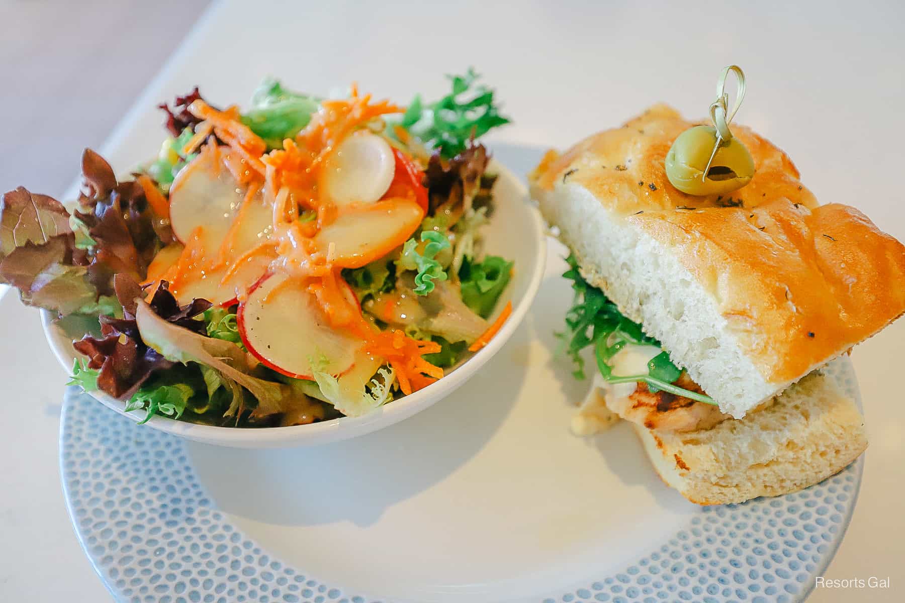 a salad and a grilled chicken sandwich from Primo Piatto 