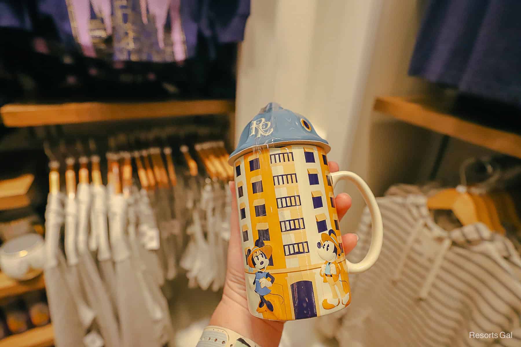 a tall mug with a lid that's shaped to look like the resort tower 
