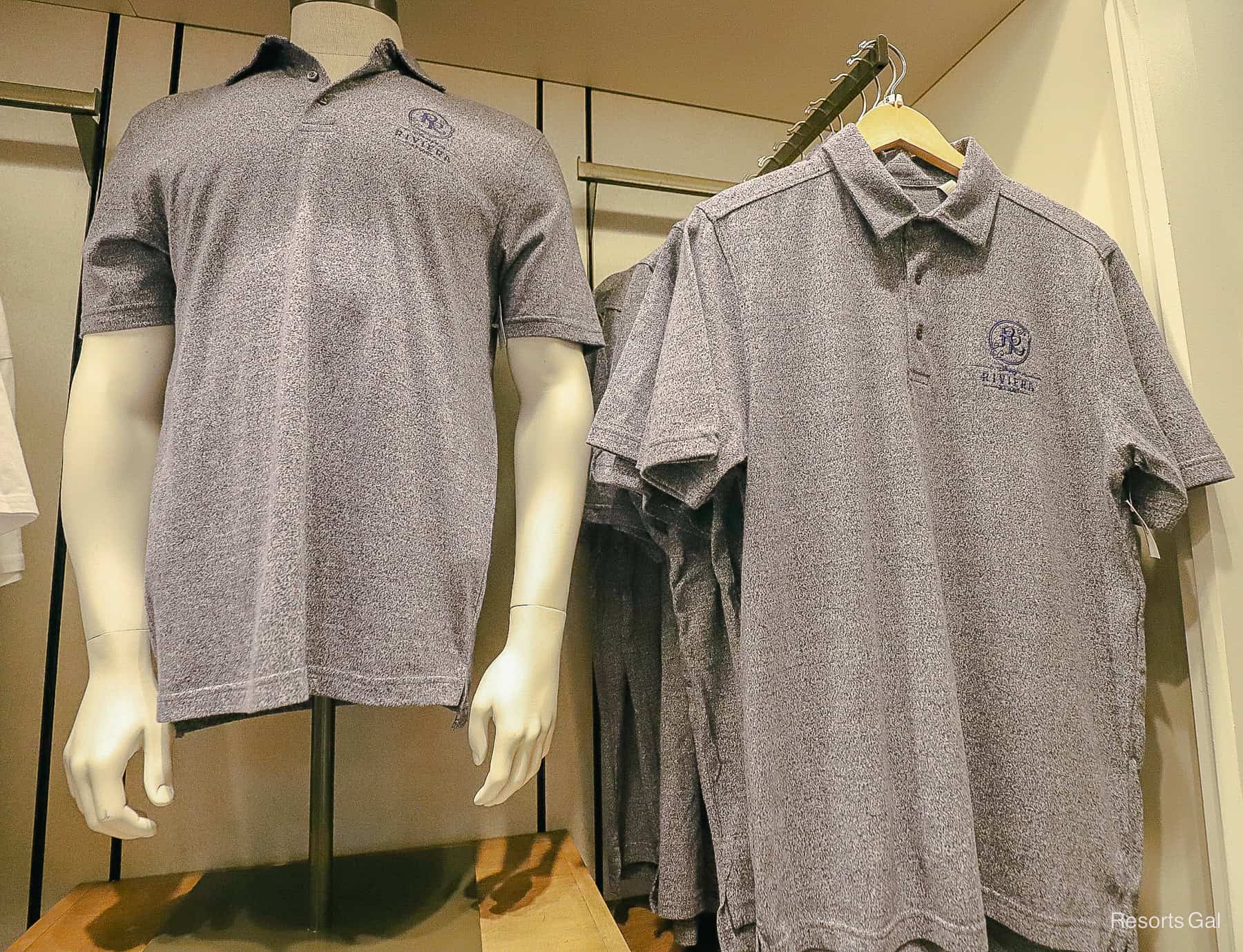 a navy men's polo with the resort logo 