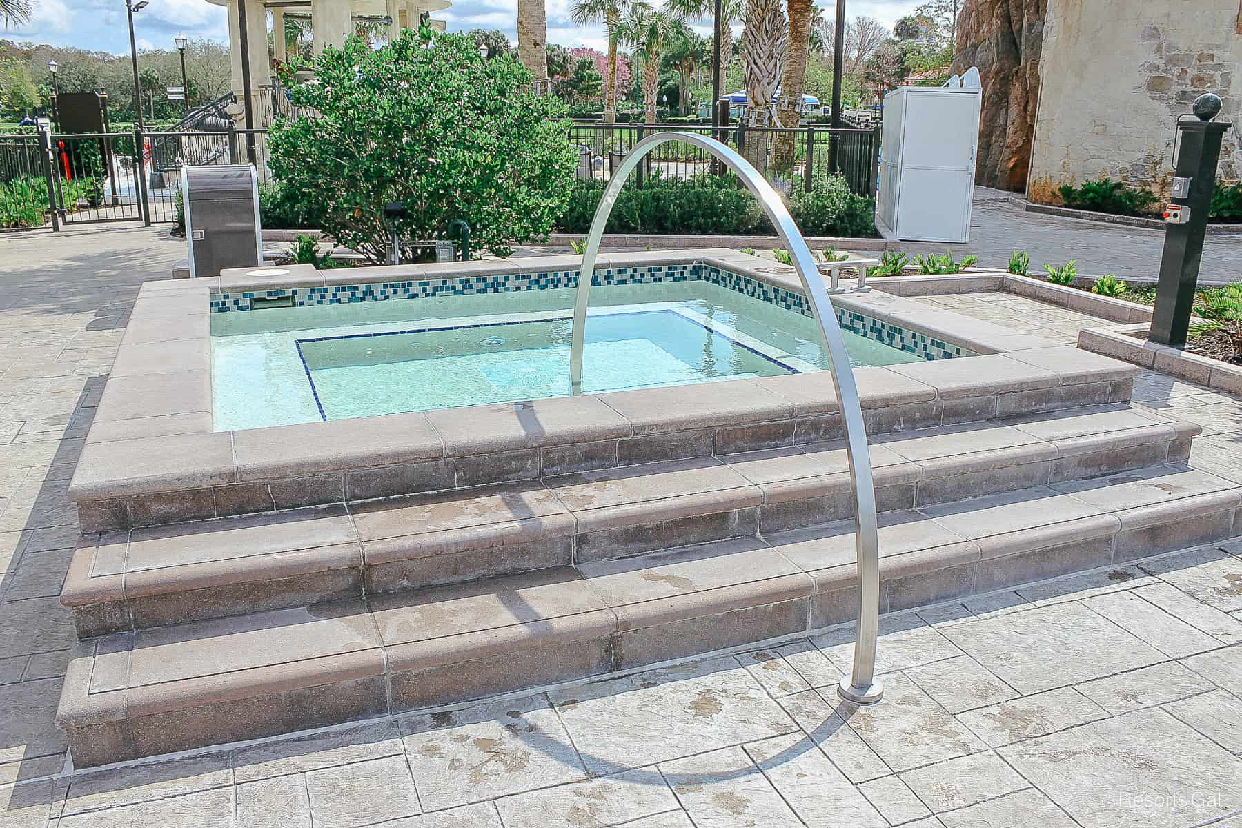 a close up of the hot tub with Mosaic tile trim 