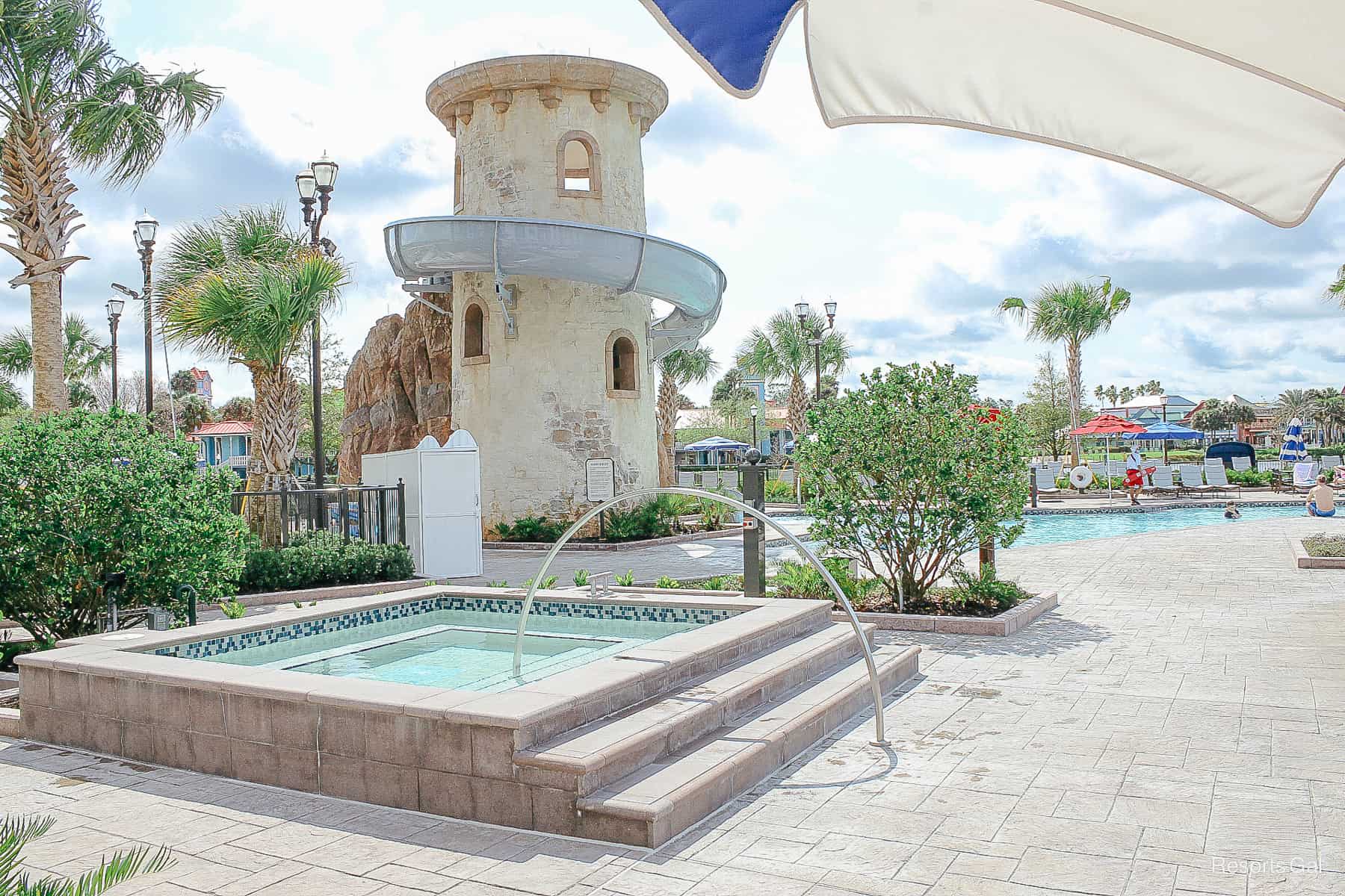 the hot tub at Disney's Riviera with the water slide in the background 