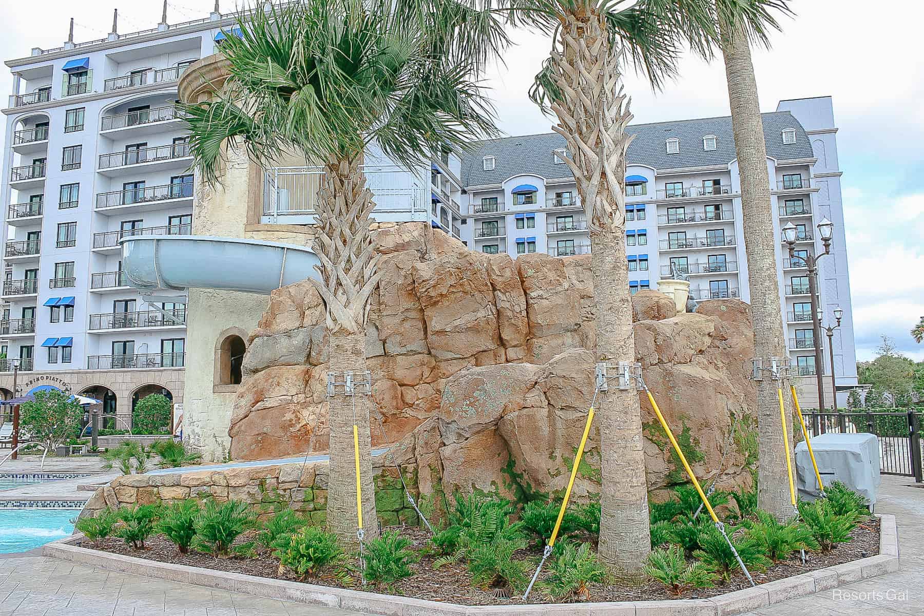 a rock structure that wraps around the water slide 