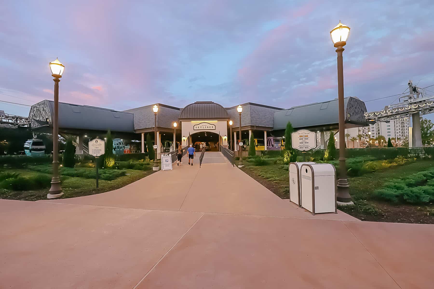 the Skyliner station at Disney's Riviera with a purple and pink sunset background