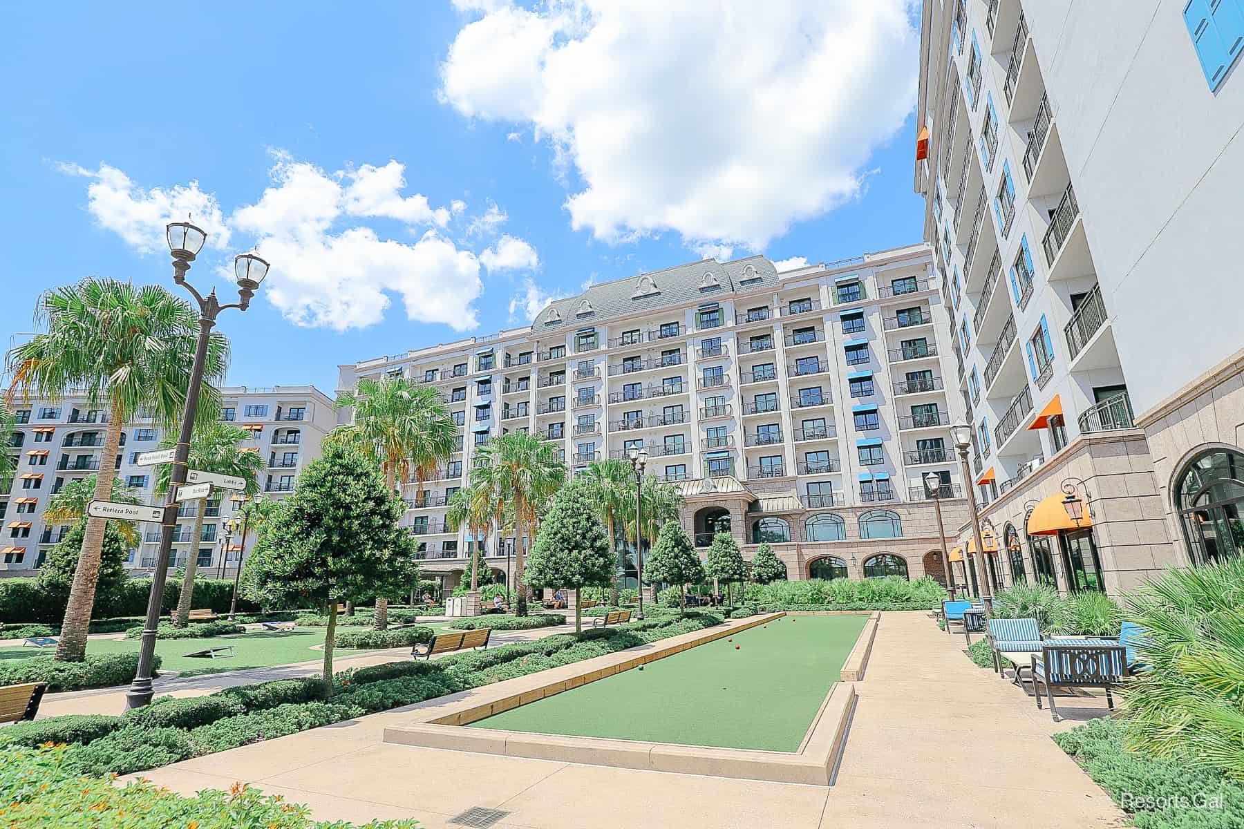 the resort side of Disney's Riviera with a long green Bocce ball court 
