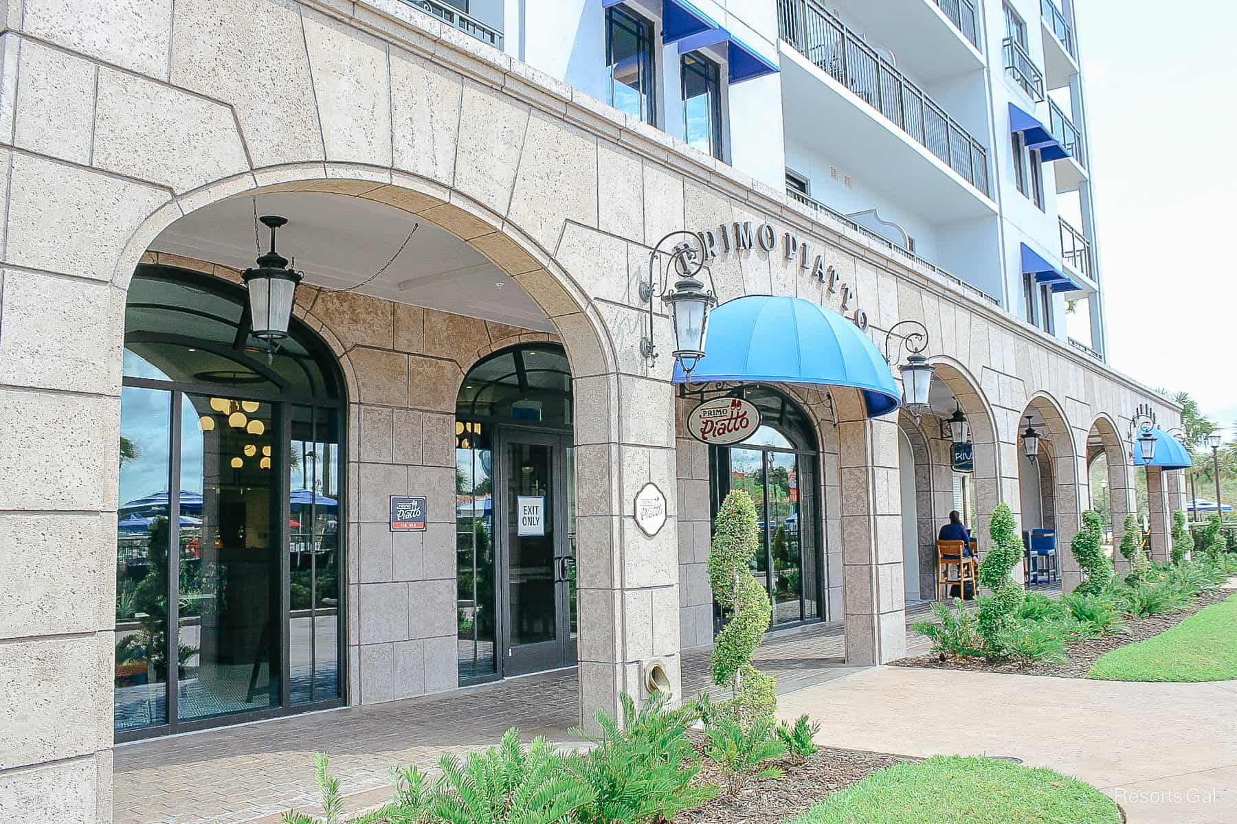 the outside entrance of Primo Piatto with a blue awning at Disney's Riviera 