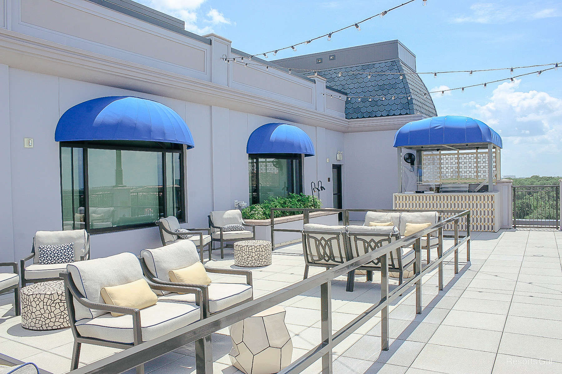 a couple of chairs and patio furniture on the rooftop terrace of Disney's Riviera Resort 