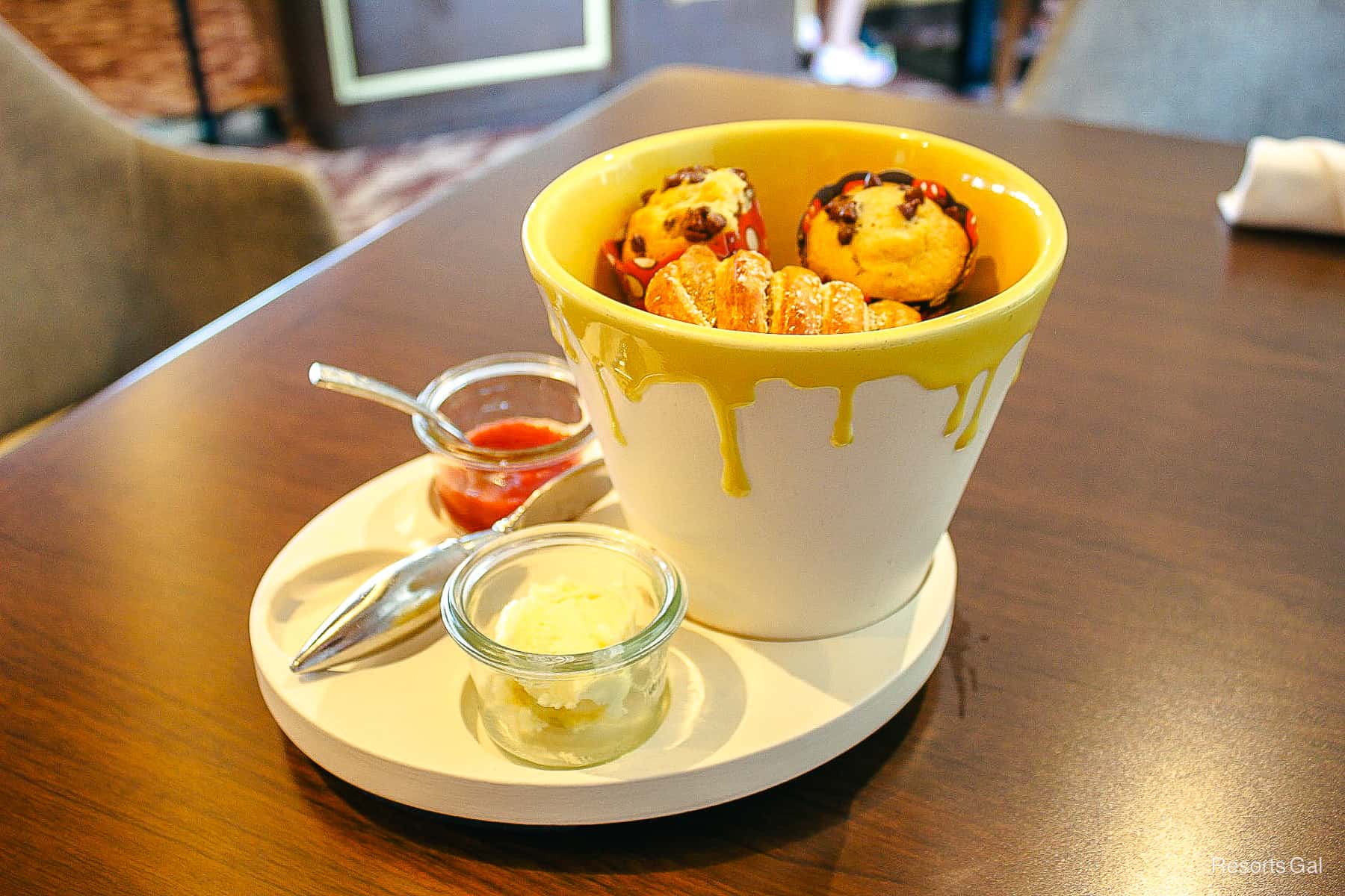 a bucket of pastries made to look like a paint bucket with yellow paint dripping down the sides 