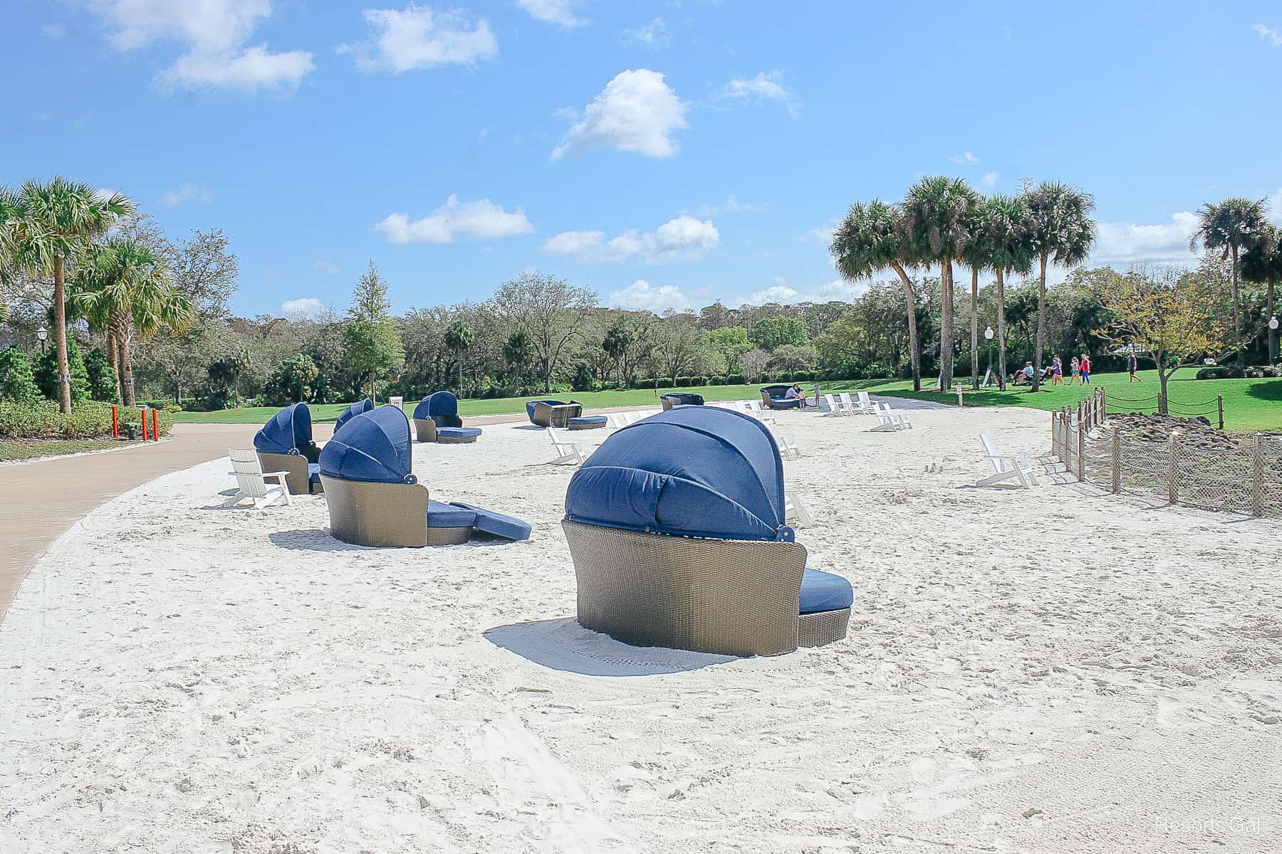 large loungers for two with shades on the white sand beach at Disney's Riviera 