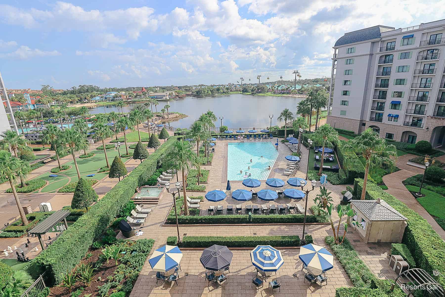 a view that show numerous landmarks including the pool, lake, and Skyliner from a preferred view room