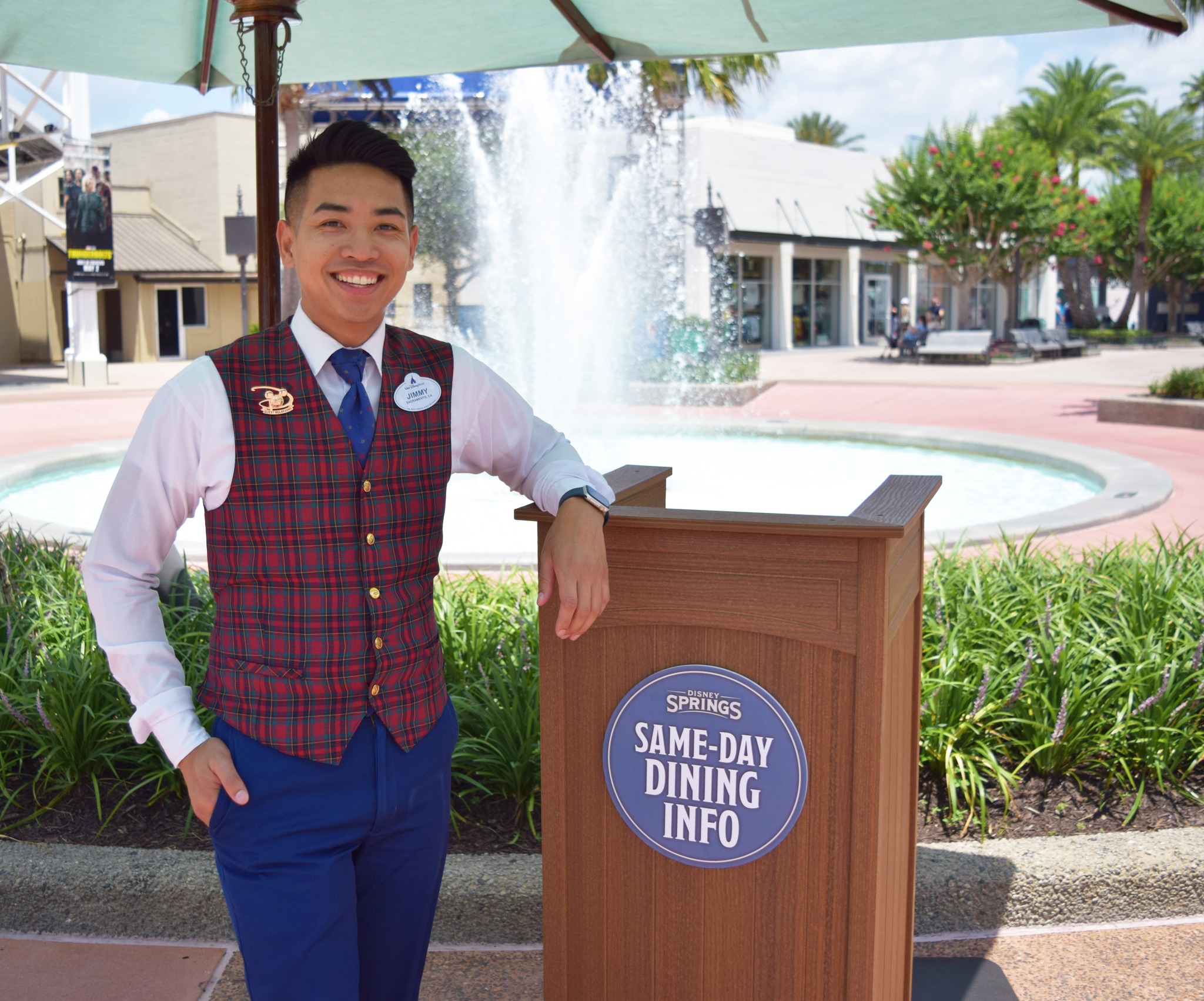 a cast member at the same day dining podium at Disney Springs