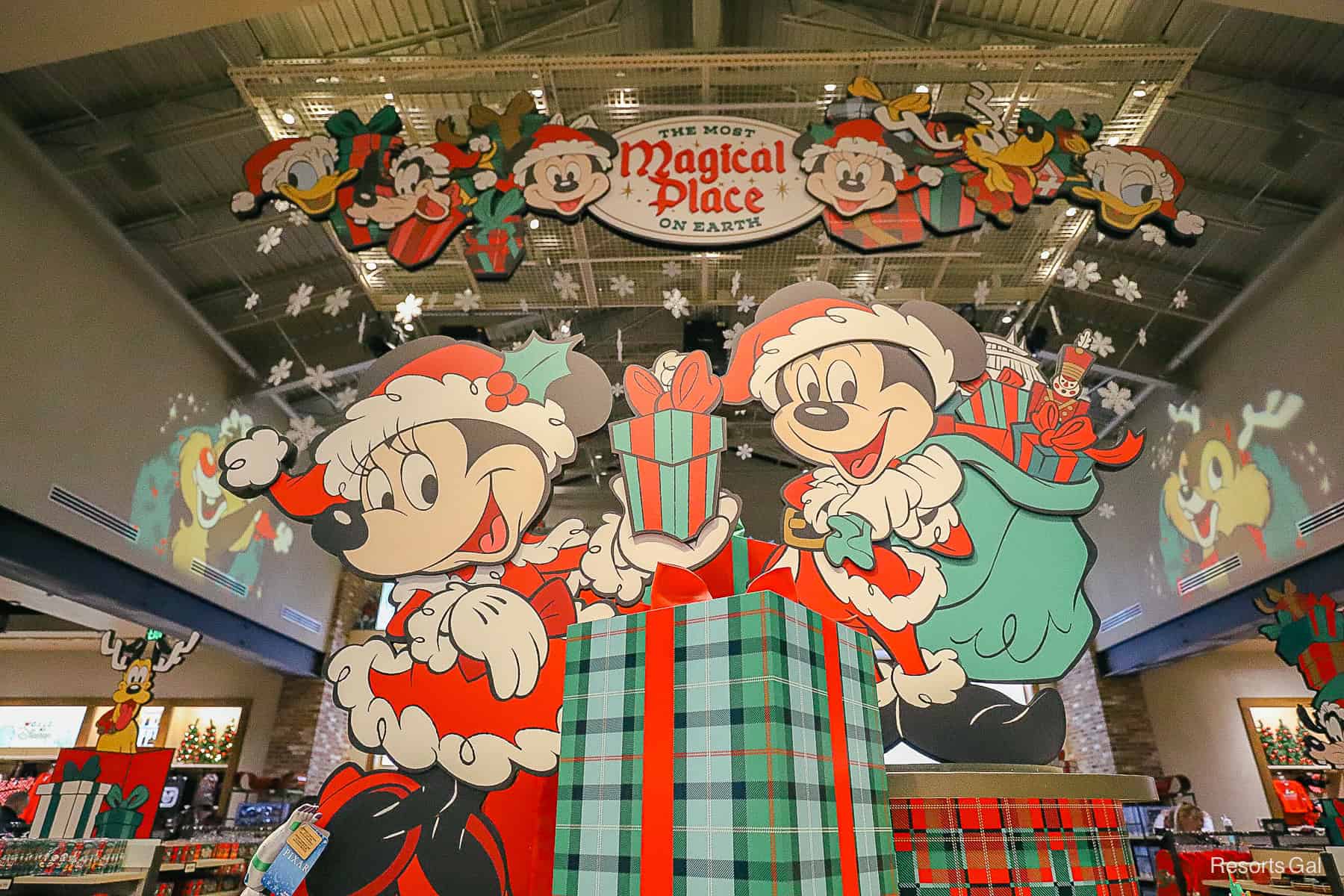 a display in World of Disney at Disney Springs that features classic characters in Christmas costumes 