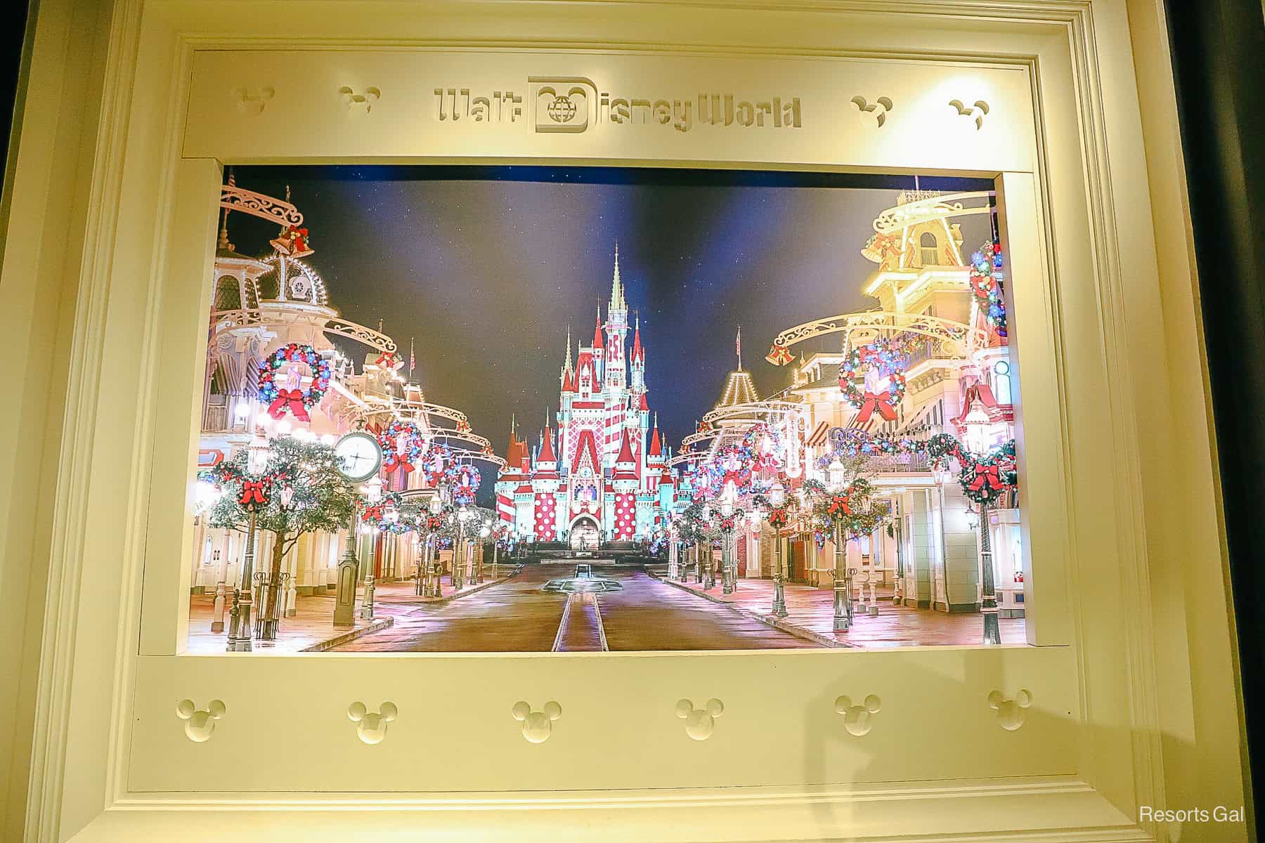 a photo wall with Cinderella Castle and Main Street U.S.A. in holiday decor at Disney Style at Disney Springs