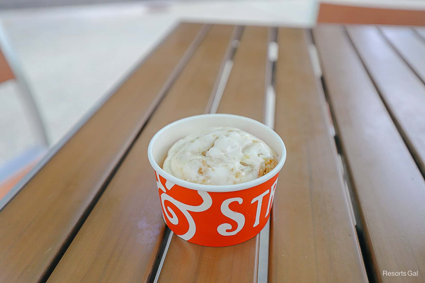 a cup of ice cream on an outdoor table at Disney Springs