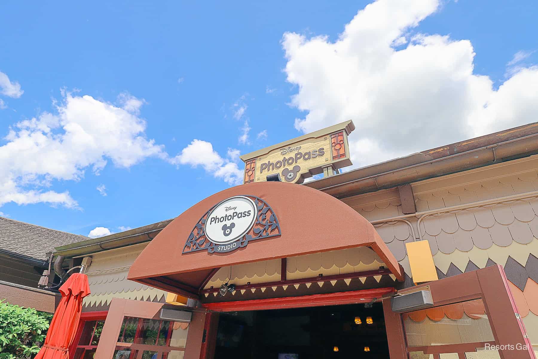 signage for the PhotoPass Studios at Disney Springs with a brown awning