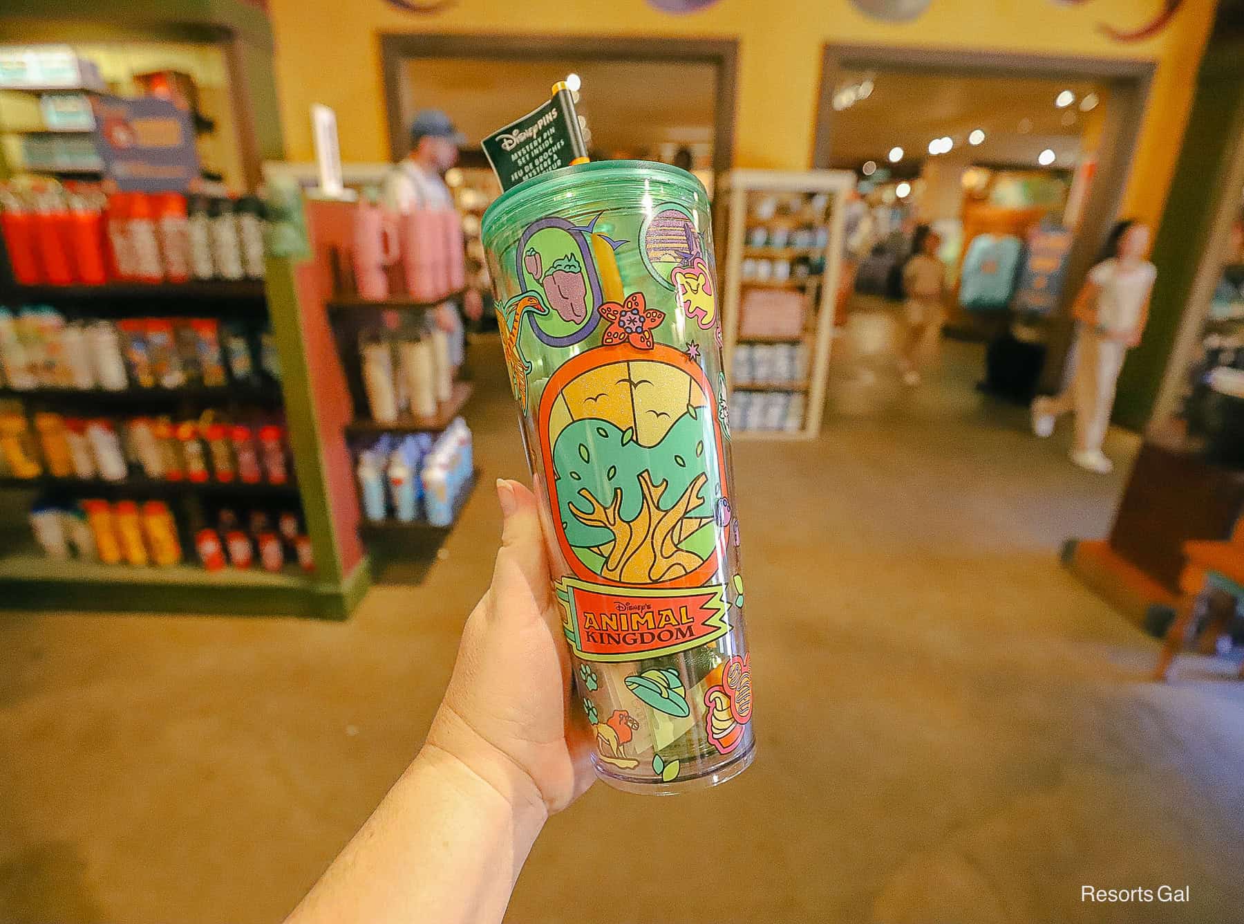 a hand holding the Animal Kingdom Starbucks Travel Tumbler 