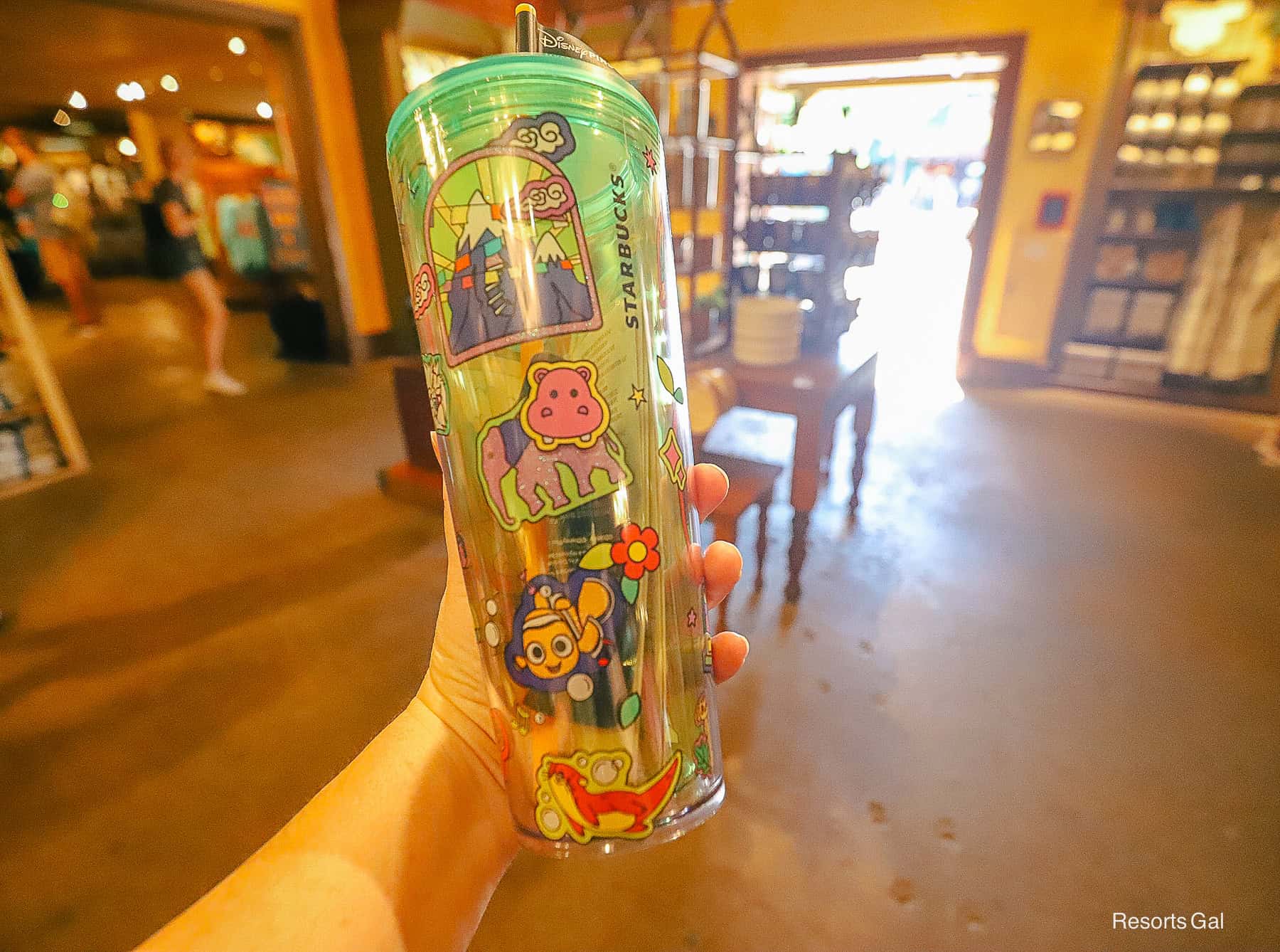 icons include Expedition Everest and Finding Nemo on the Starbucks Animal Kingdom tumbler