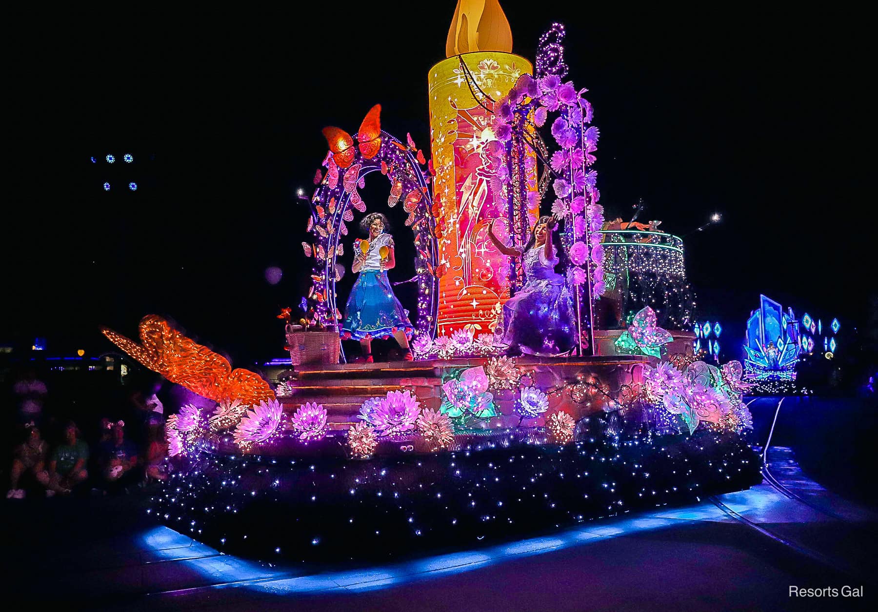 Mirabel and Isabella from Encanto ride on the float 