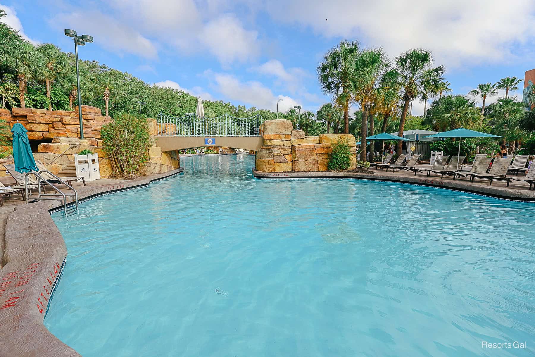 a view of the pool with a bridge crossing it 