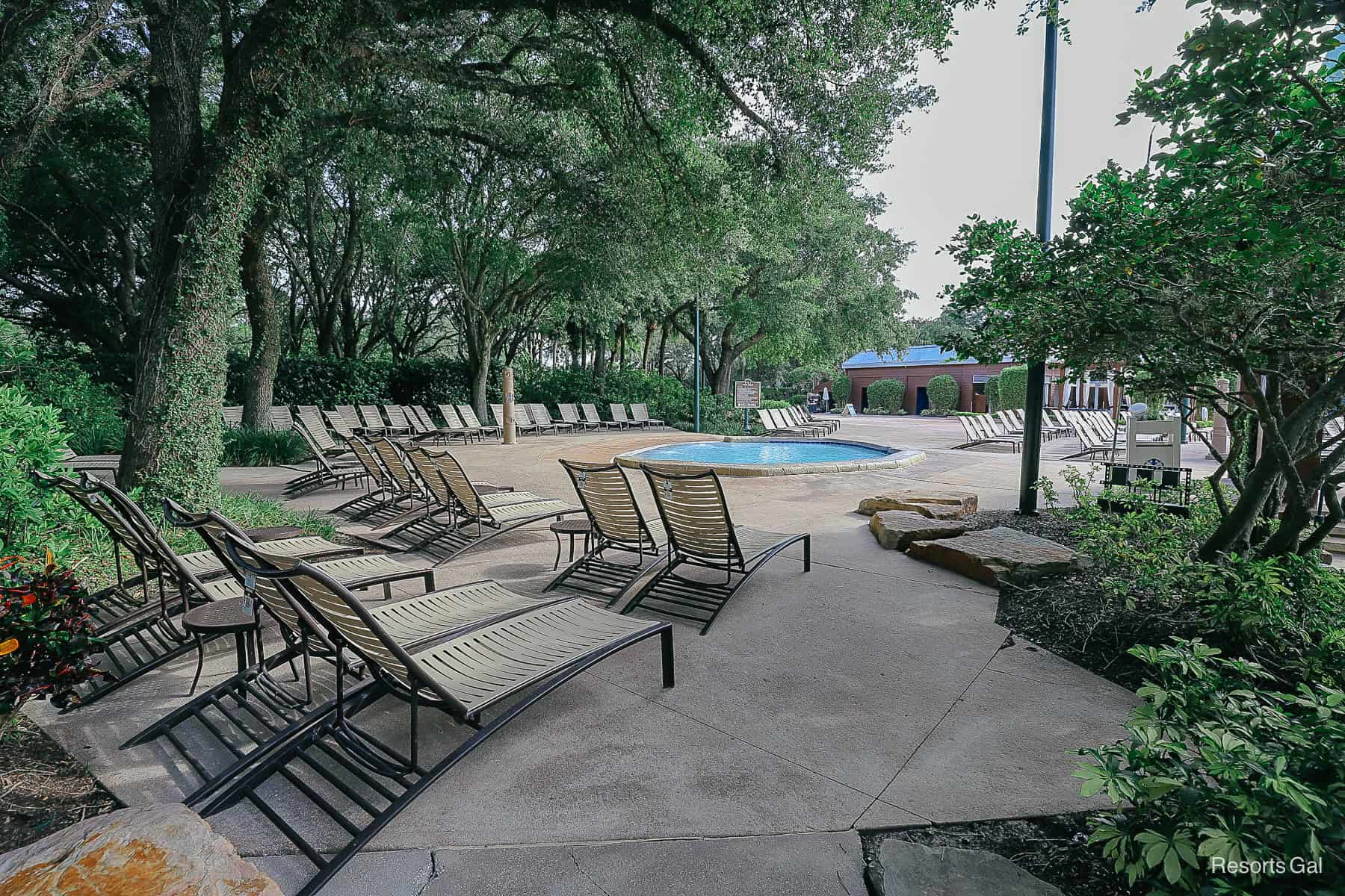 lounge chairs in a shaded area bheind the kiddie pool 