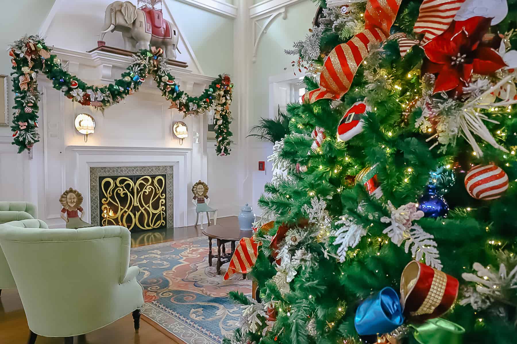 A sitting area in the lobby of Disney's Boardwalk Inn with the tree and garland. 