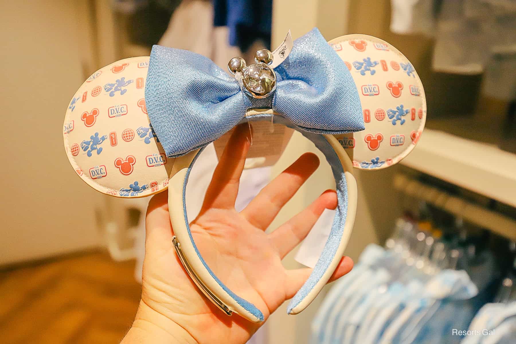 a pair of Minnie Ears with a blue bow and the DVC logo