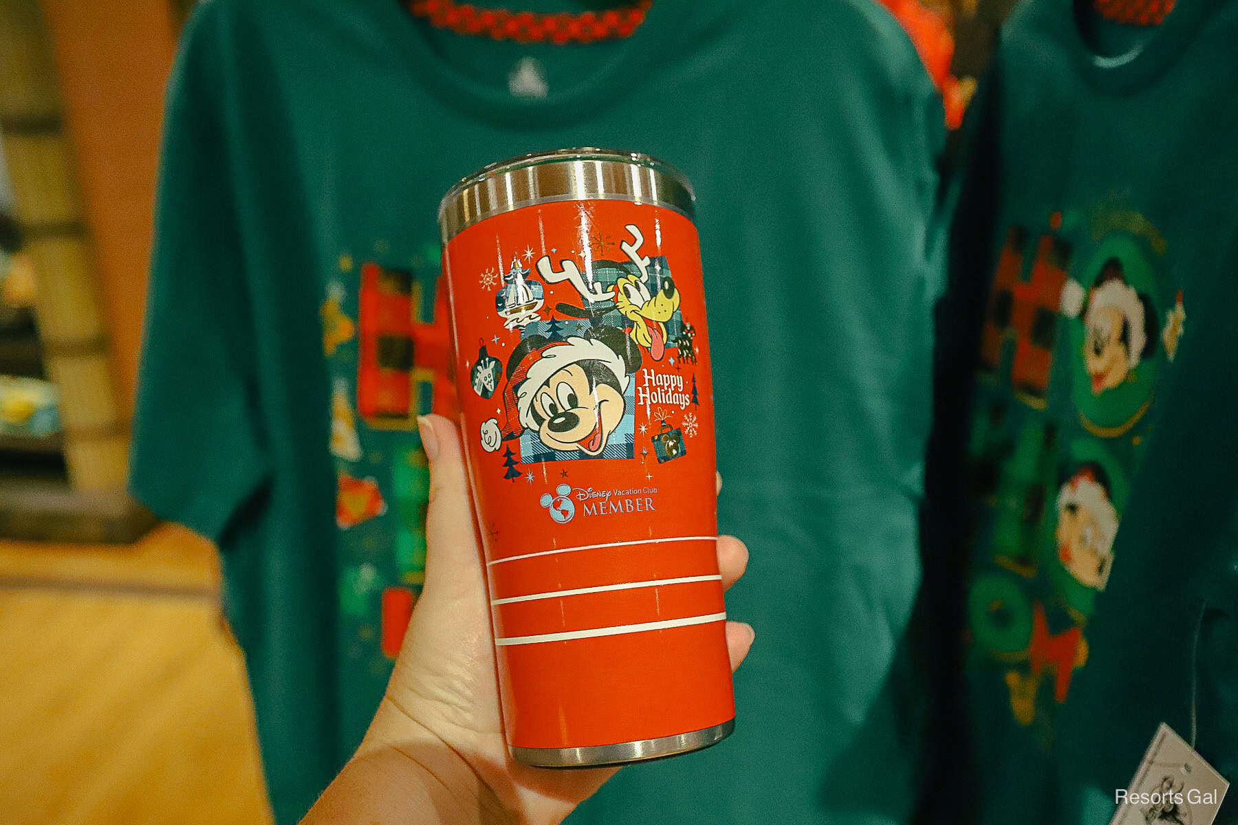 a red tumbler with Mickey and Pluto 