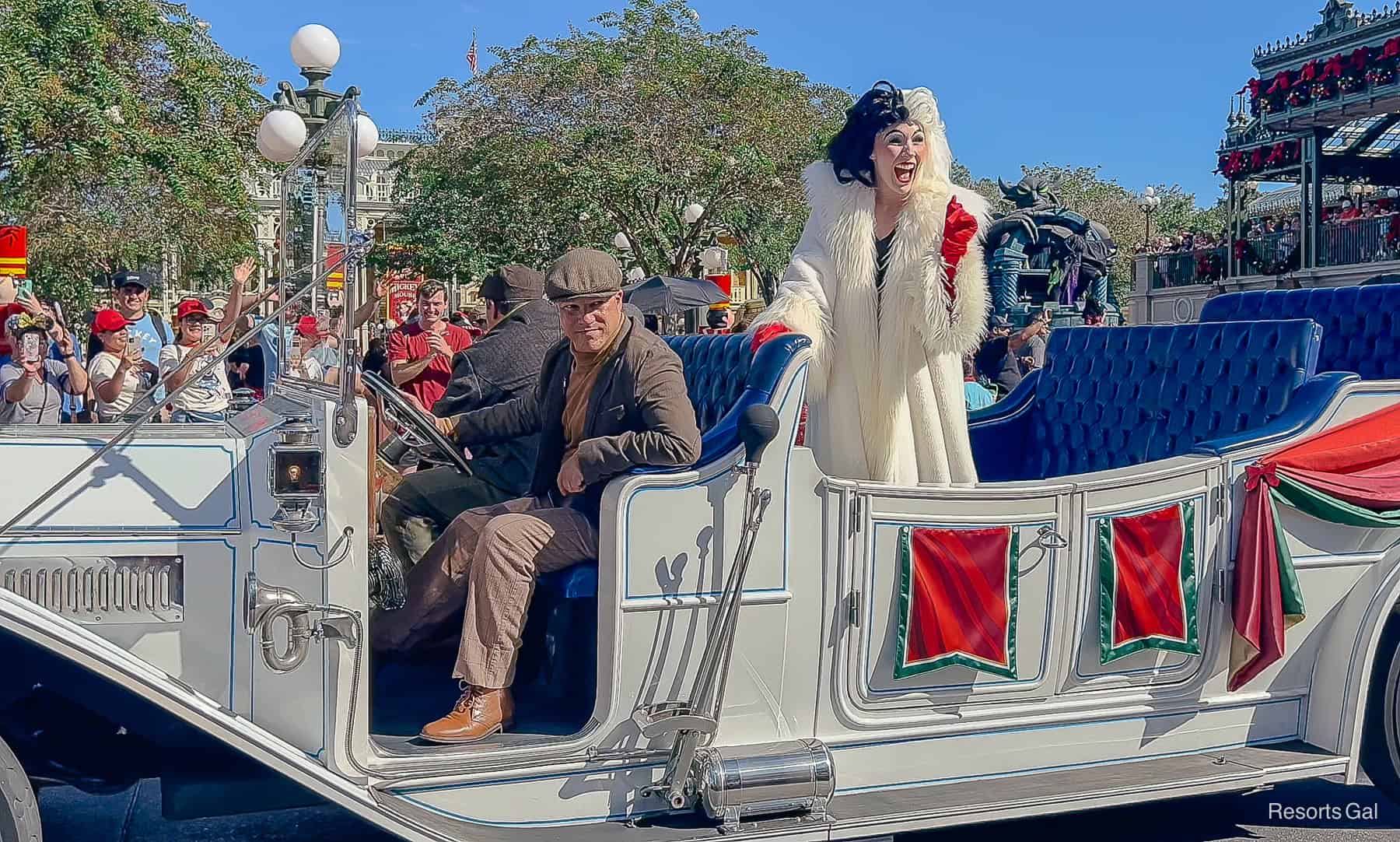 Cruella and her henchman in the Villains holiday pre-parade at Magic Kingdom