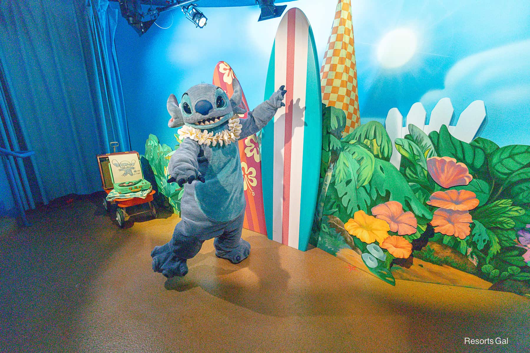 Stitch poses for a photo with arms out