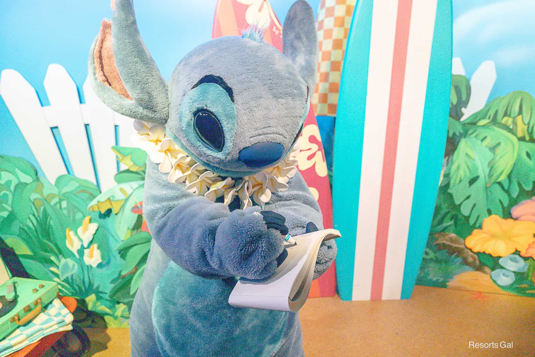 Stitch signs his autograph