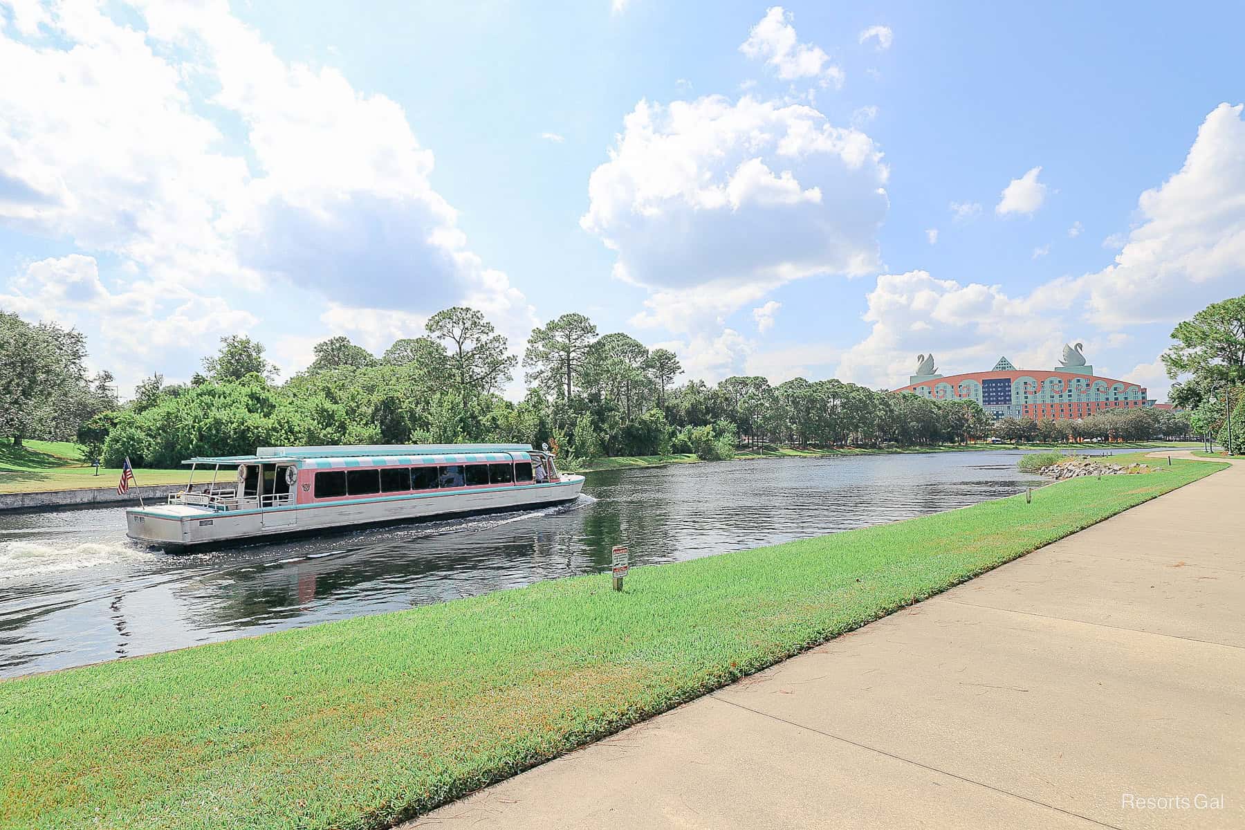 a Friendship boat passes the walking path between Hollywood Studios and Epcot
