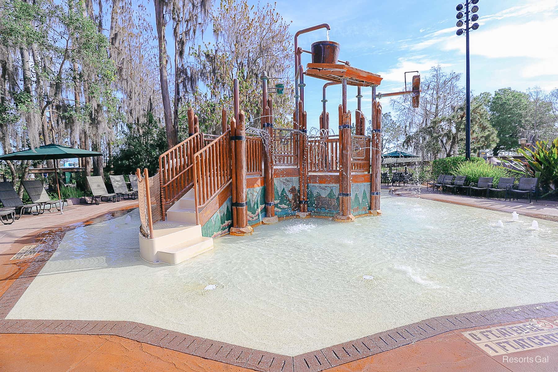 an aquatic play area in a separately fenced area designed for children 