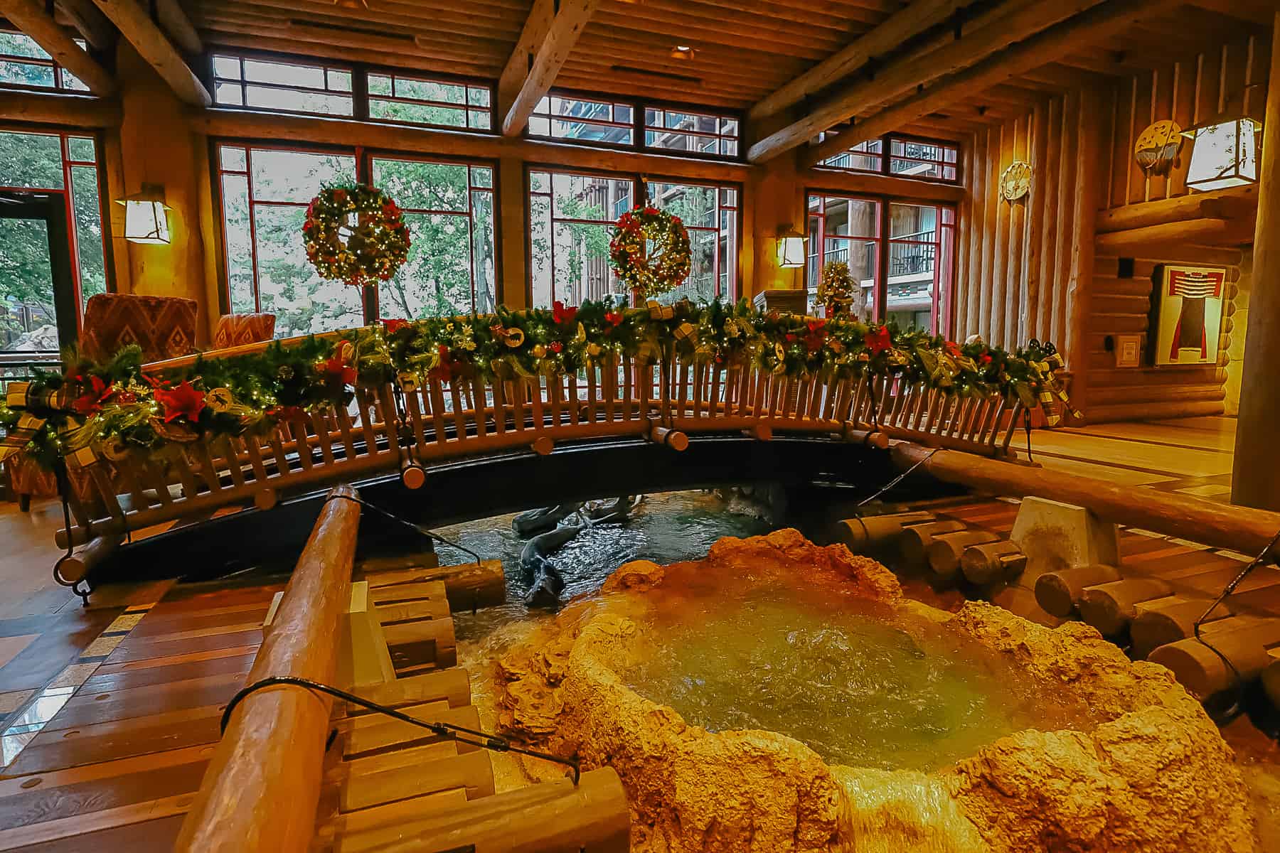 A photo that shows the entire bridge in the Disney's Wilderness Lodge lobby with holiday decorations. 