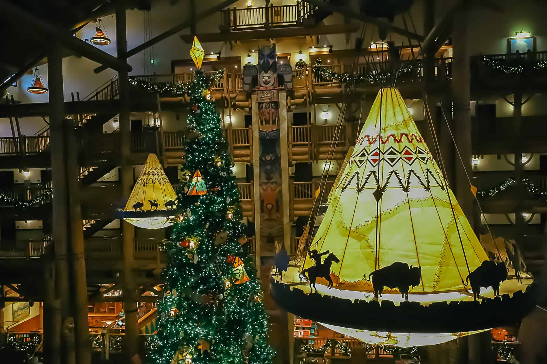 Tepee light fixtures in the Wilderness Lodge hang next to the Christmas Tree. 