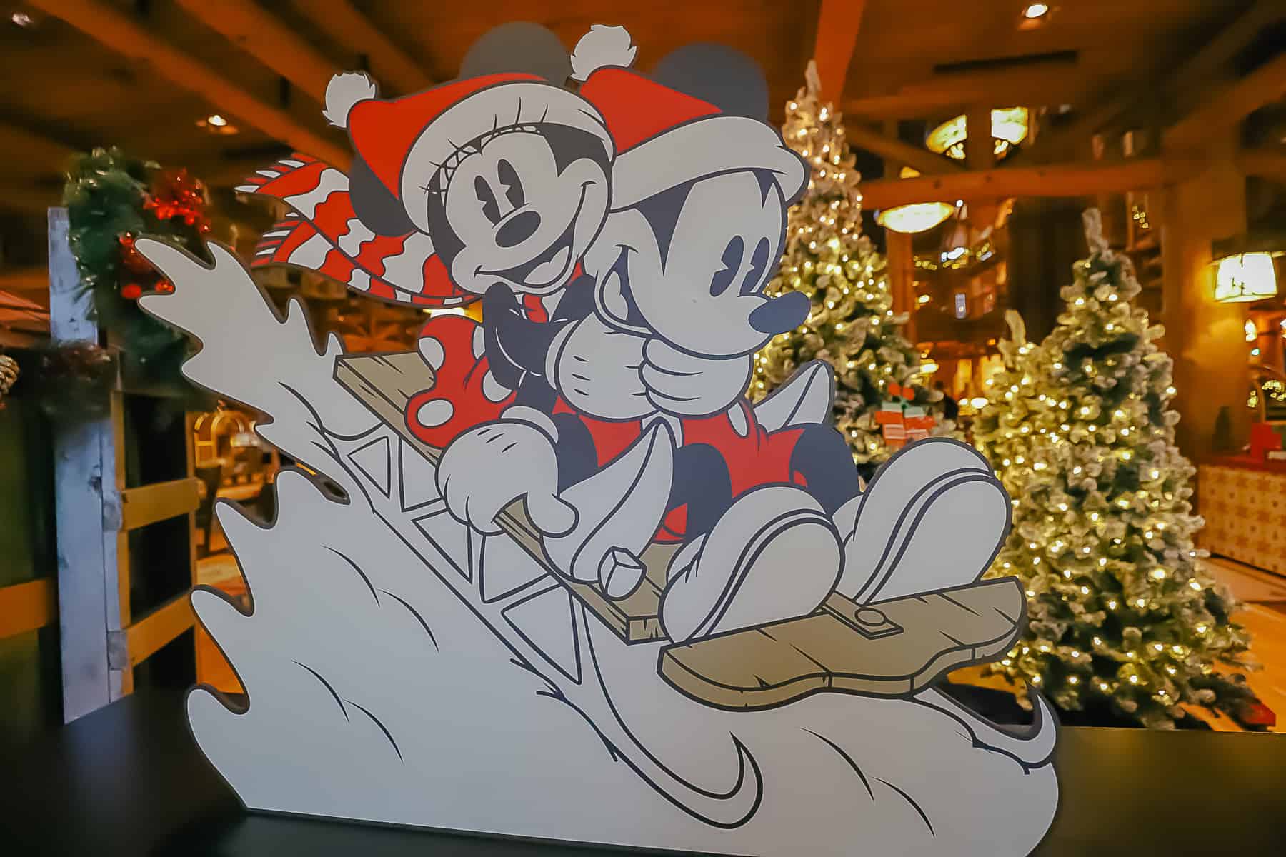 Cardboard cutout of Mickey and Minnie on a sleigh 