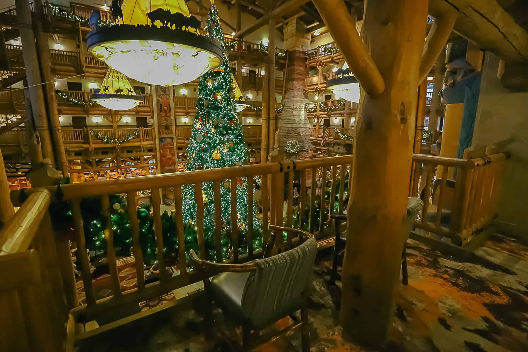 Seats are available on the upper floors to rest and take in the views of the Christmas Tree at Disney's Wilderness Lodge. 