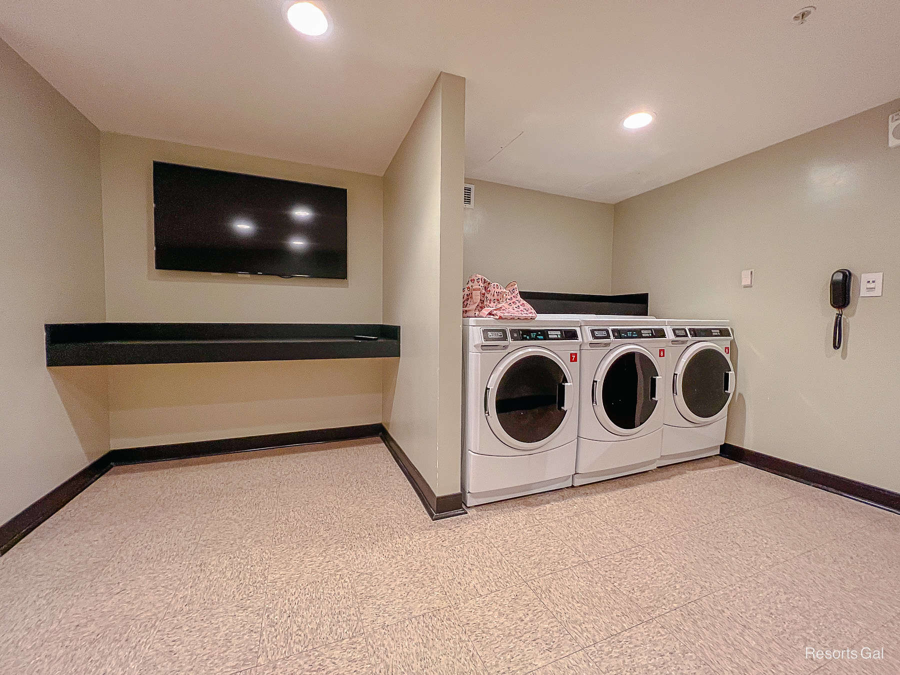 a television and folding table for guests in the laundry room 