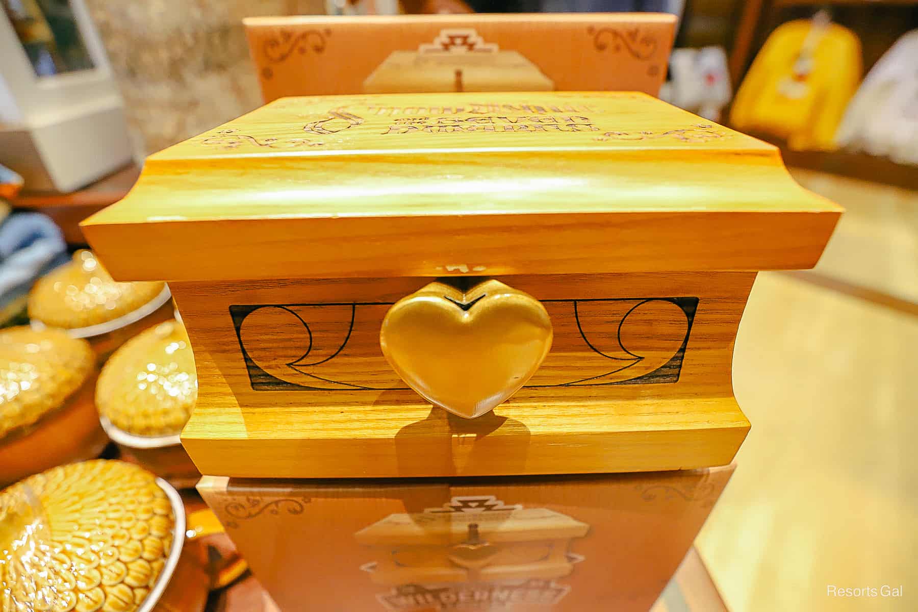 a wooden box from Snow White with a heart on the clasp 