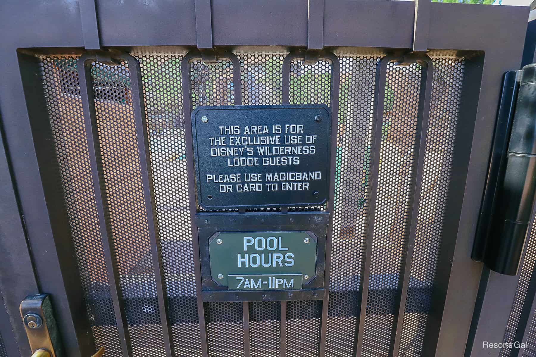 a sign with the pool hours for the quiet pool at Wilderness Lodge 