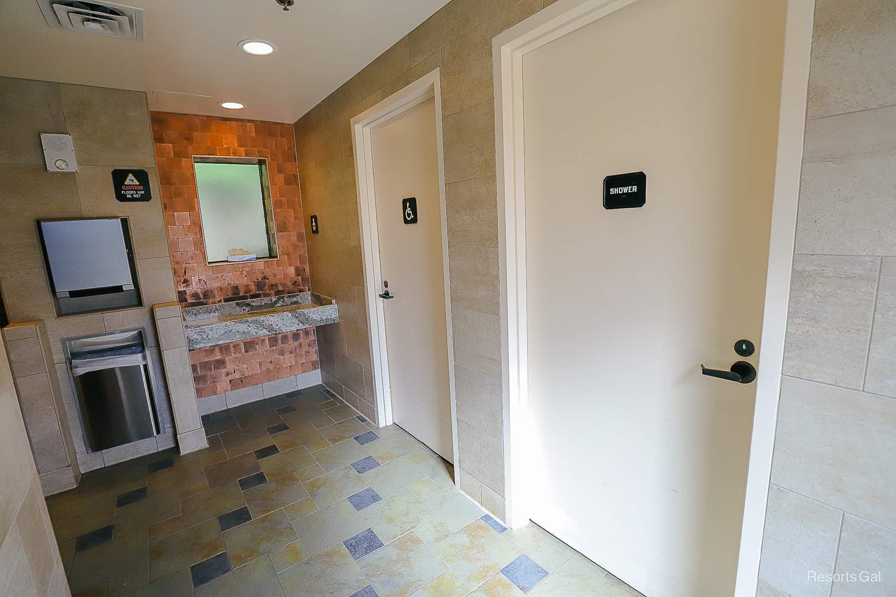 the interior of the pool restroom that shows a handicap area and a shower 