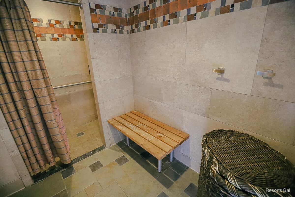 the shower with a bench and changing area at the pools at Wilderness Lodge 