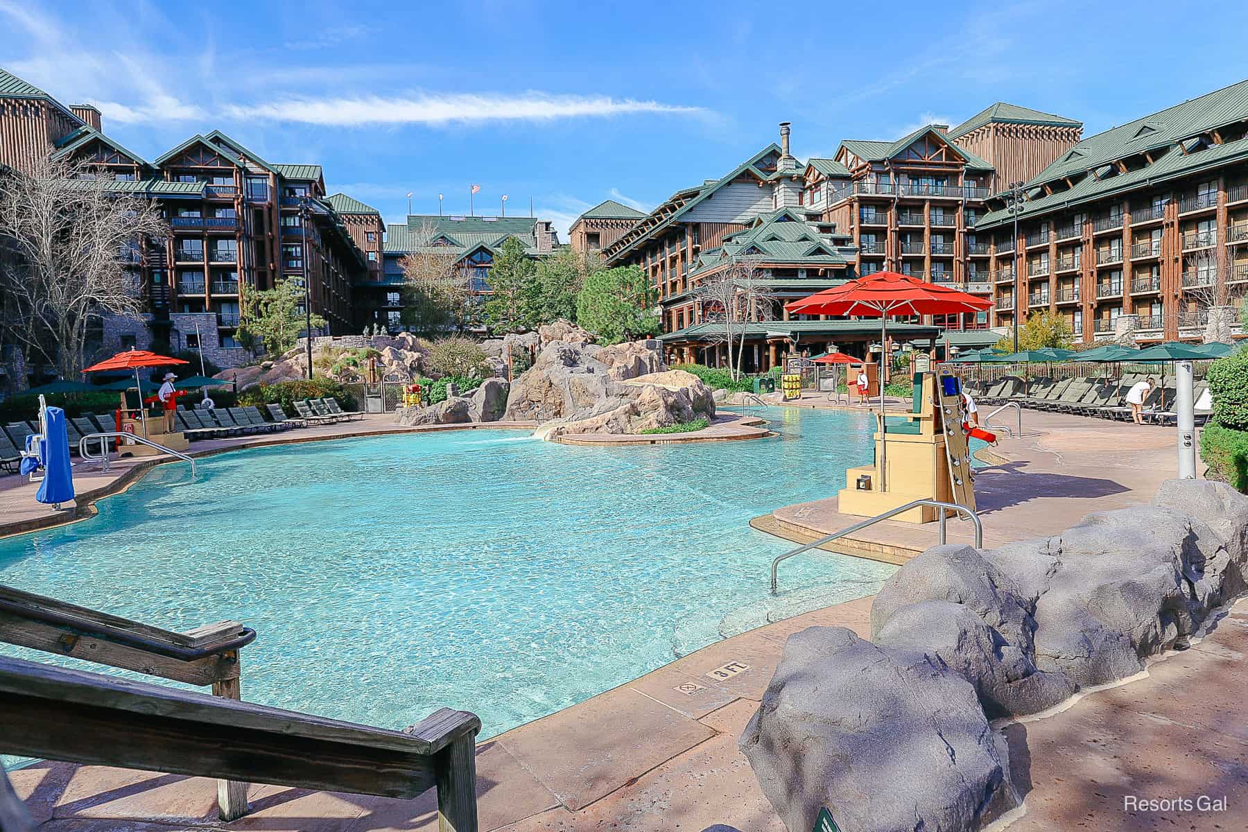 an overview of the entire pool with bright red umbrellas 