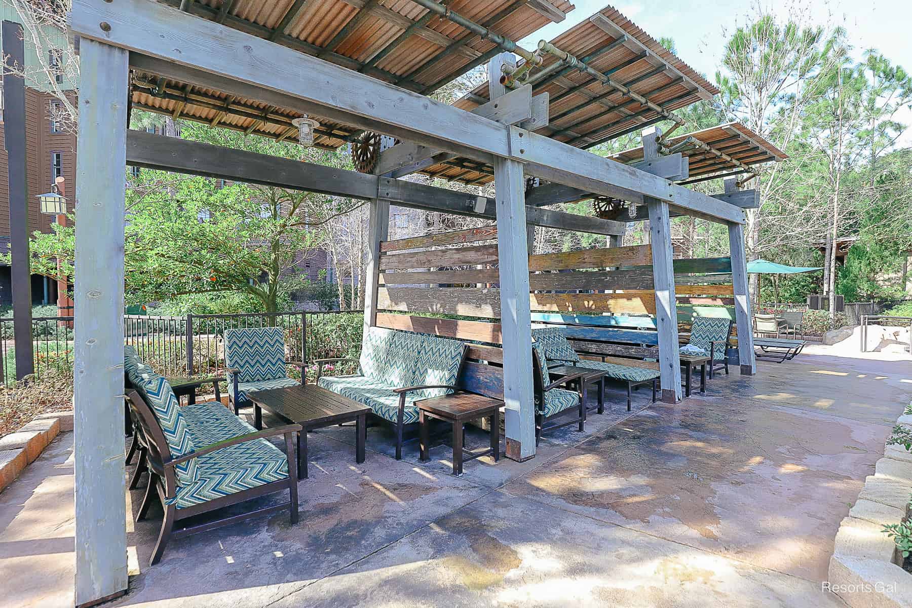 a few cabanas that have benches and tables with chairs 