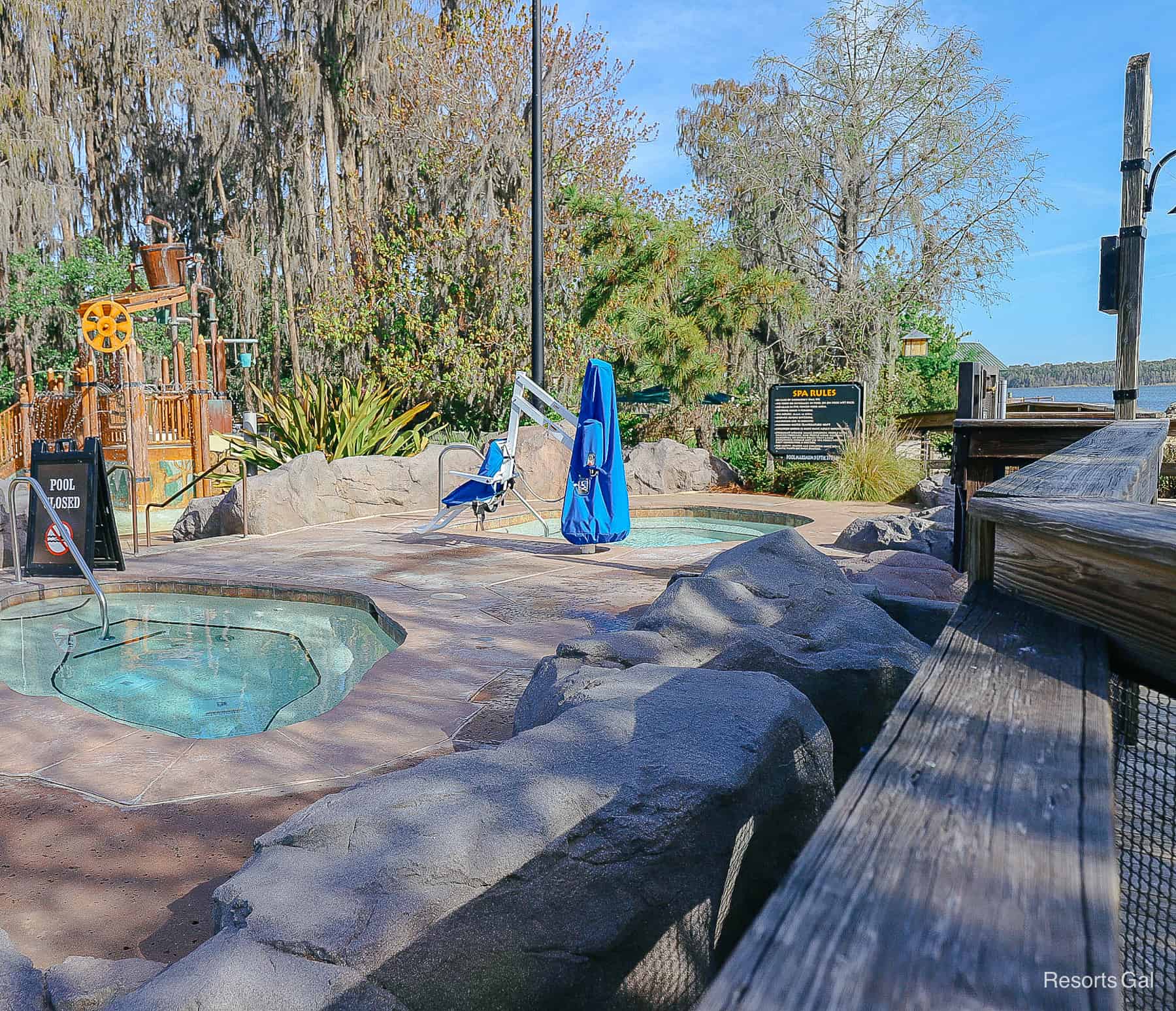 two hot tubs sitting in a private area among rocks 