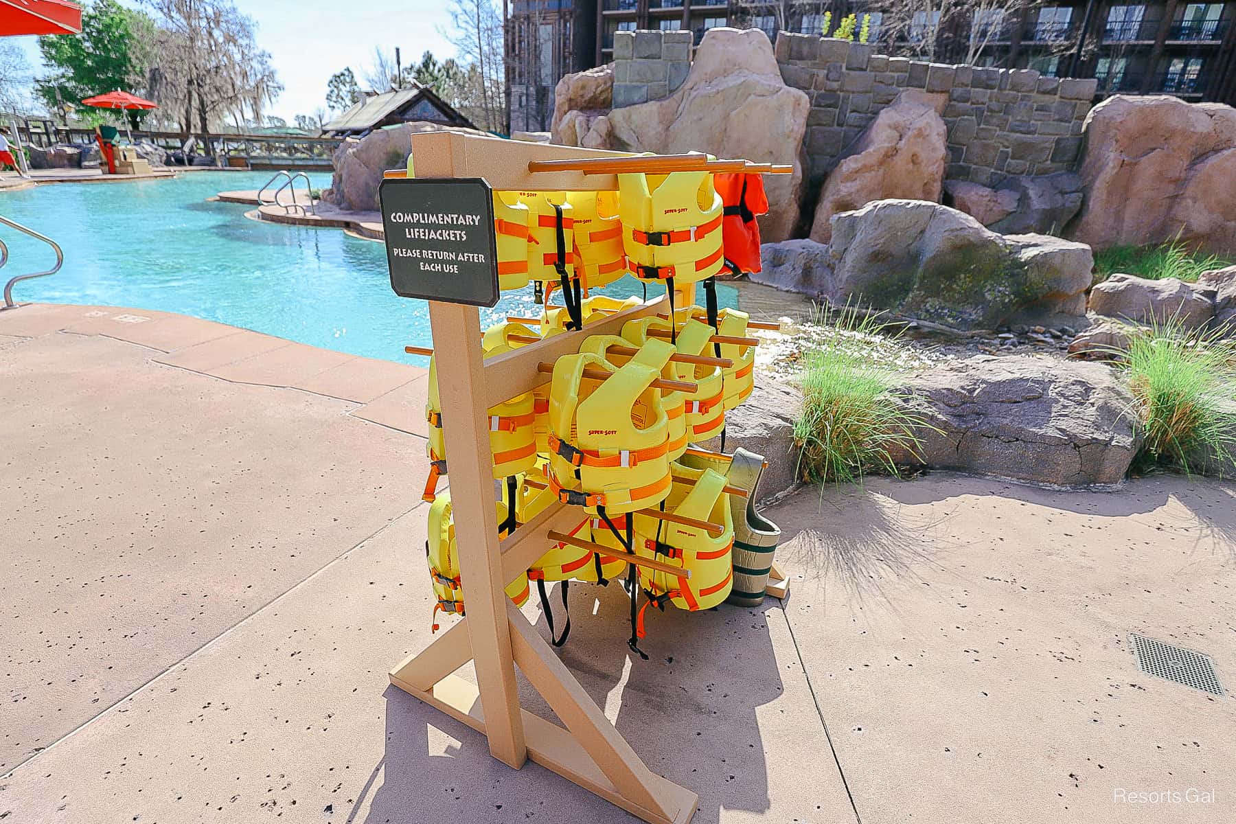 a stand with complimentary life jackets in yellows and oranges