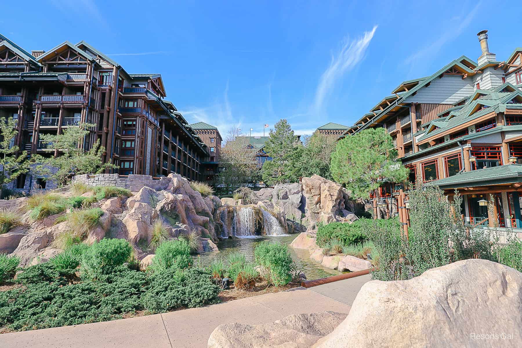 a view of Disney's Wilderness Lodge with Copper Creek Falls in front of it 